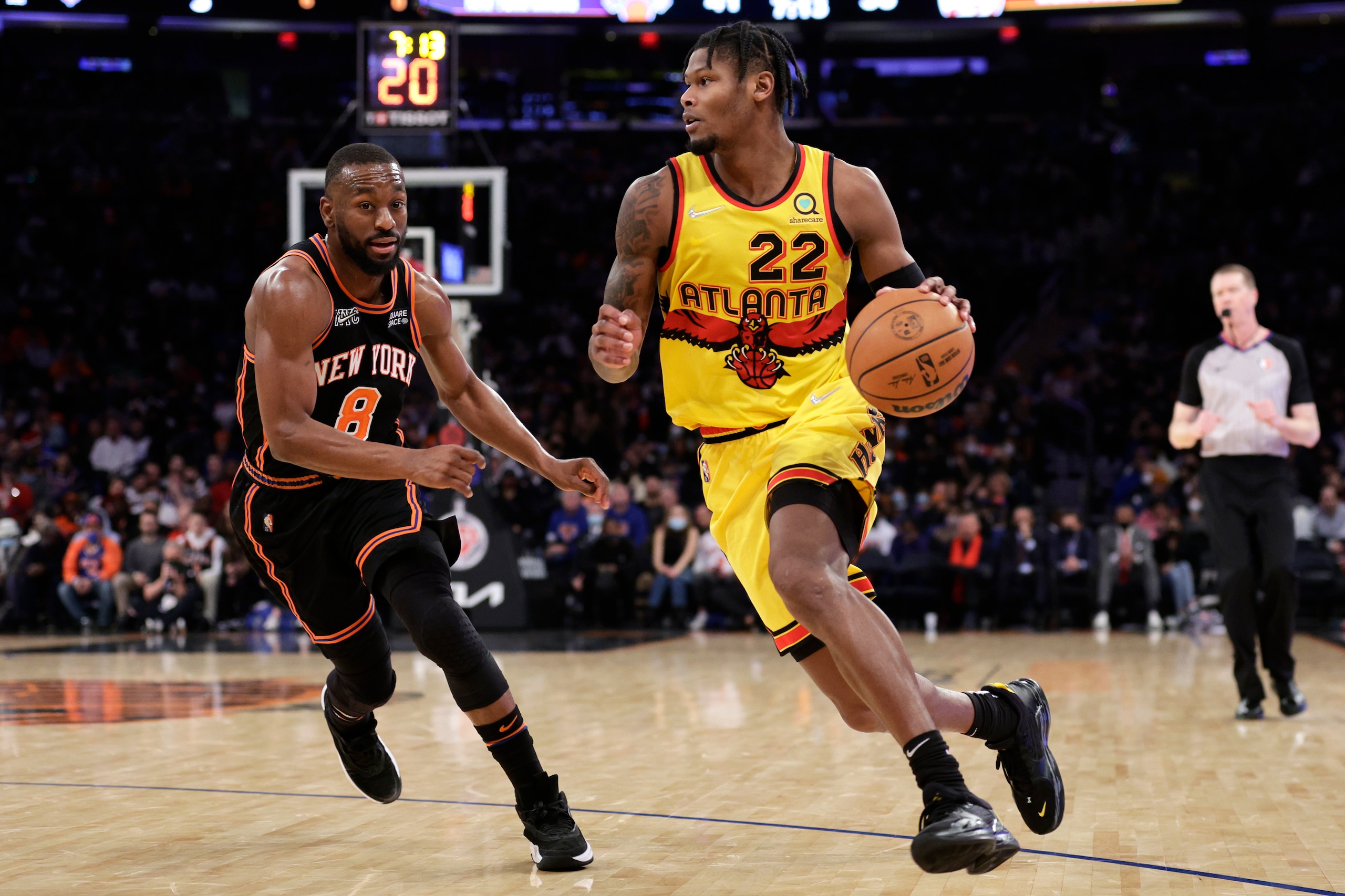 Atlanta Hawks forward Cam Reddish (22) drives past New York Knicks guard Kemba Walker during the first half of an NBA basketball game Saturday, Dec. 25, 2021, in New York. (AP Photo/Adam Hunger)