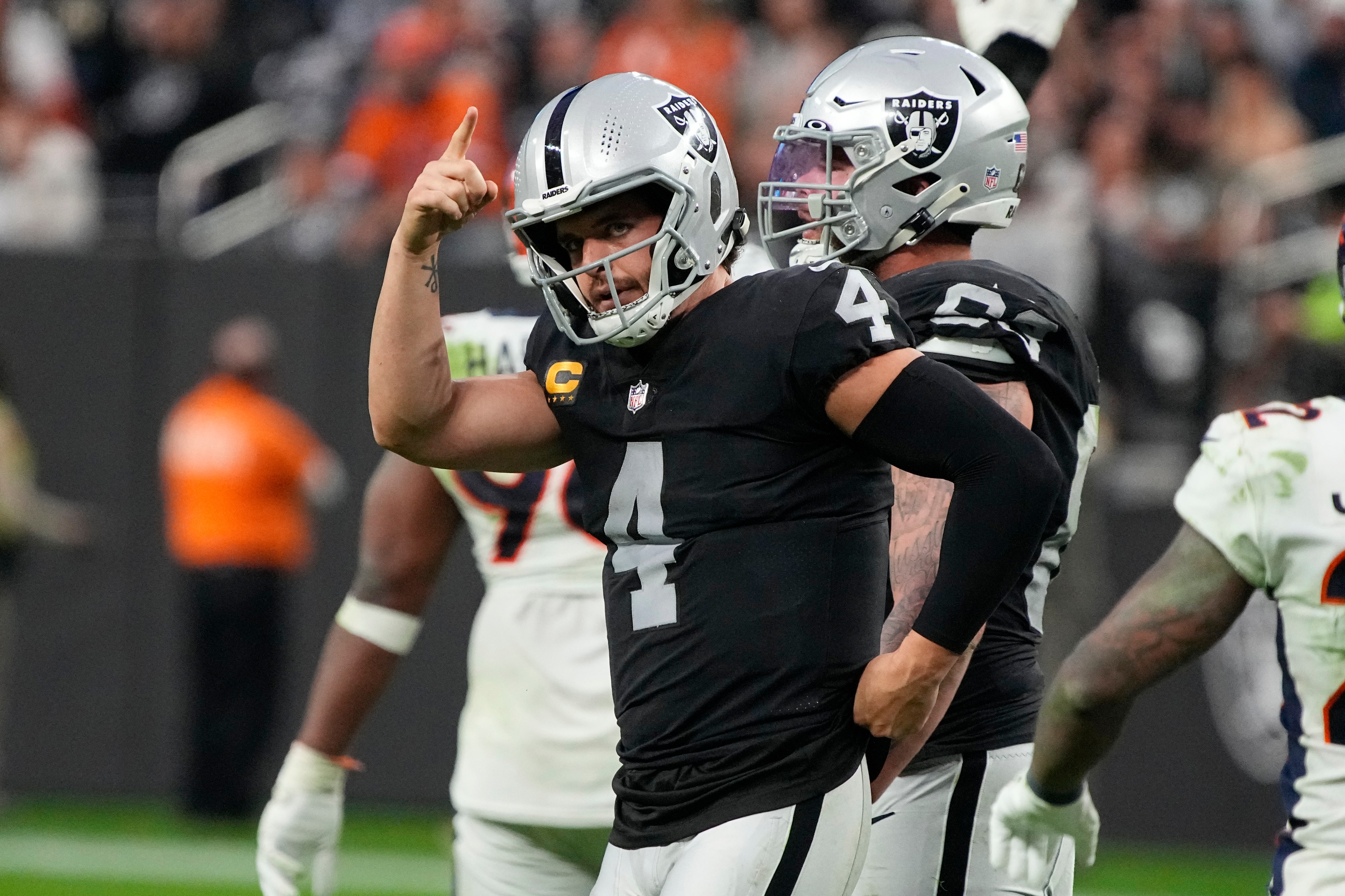 Las Vegas Raiders quarterback Derek Carr (4) motions against the Denver Broncos during the second half of an NFL football game, Sunday, Dec. 26, 2021, in Las Vegas. (AP Photo/Rick Scuteri)a