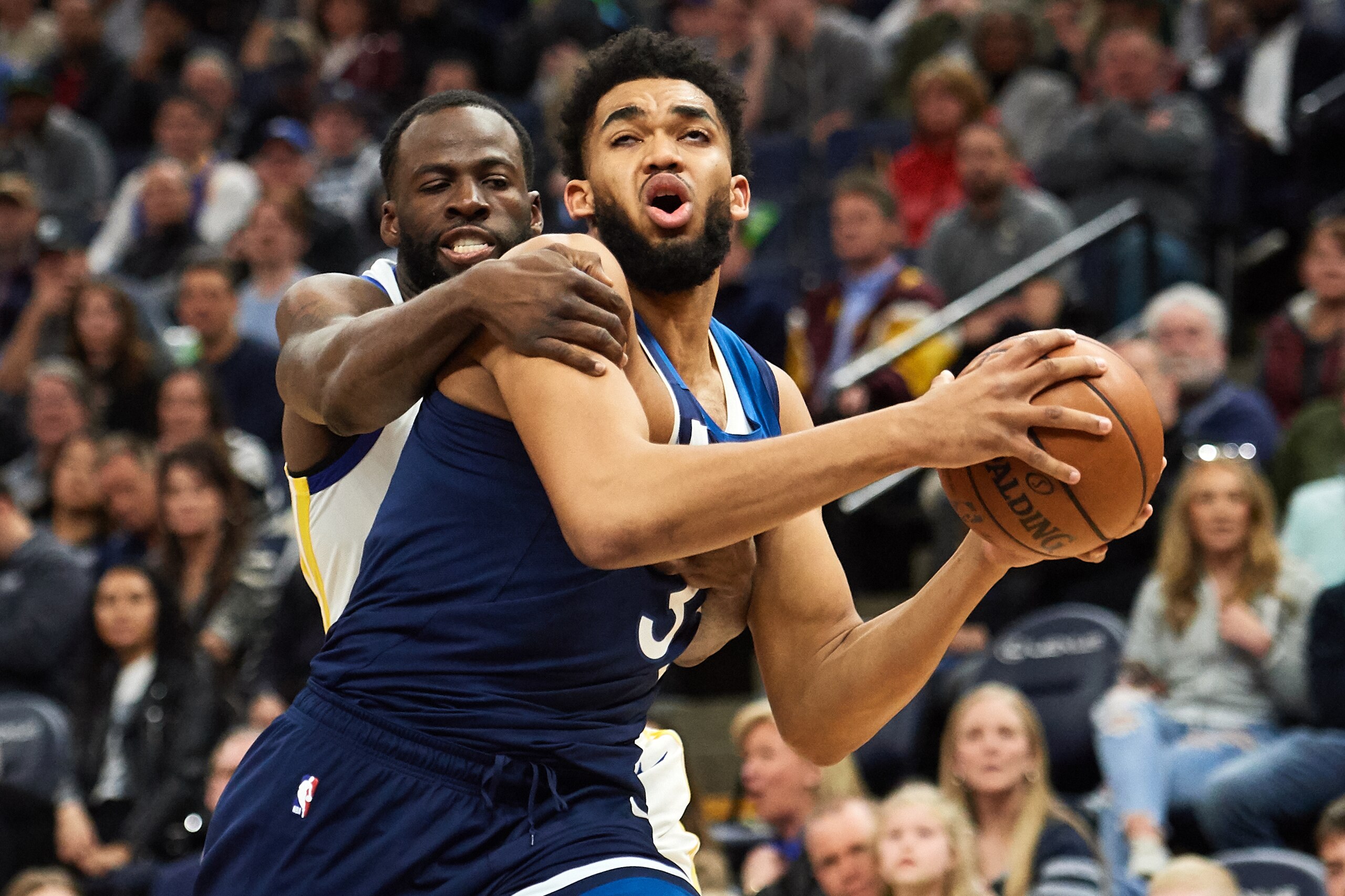 MINNEAPOLIS, MN - MARCH 29: Draymond Green #23 of the Golden State Warriors fouls Karl-Anthony Towns #32 of the Minnesota Timberwolves during the game on March 29, 2019 at the Target Center in Minneapolis, Minnesota. NOTE TO USER: User expressly acknowledges and agrees that, by downloading and or using this Photograph, user is consenting to the terms and conditions of the Getty Images License Agreement. (Photo by Hannah Foslien/Getty Images)