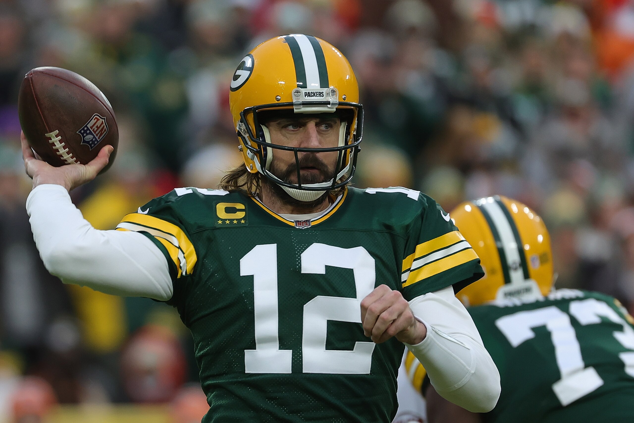 GREEN BAY, WISCONSIN - DECEMBER 25: Aaron Rodgers #12 of the Green Bay Packers drops back to pass during a game against the Cleveland Browns at Lambeau Field on December 25, 2021 in Green Bay, Wisconsin.  The Packers defeated the Browns 24-22. (Photo by Stacy Revere/Getty Images)