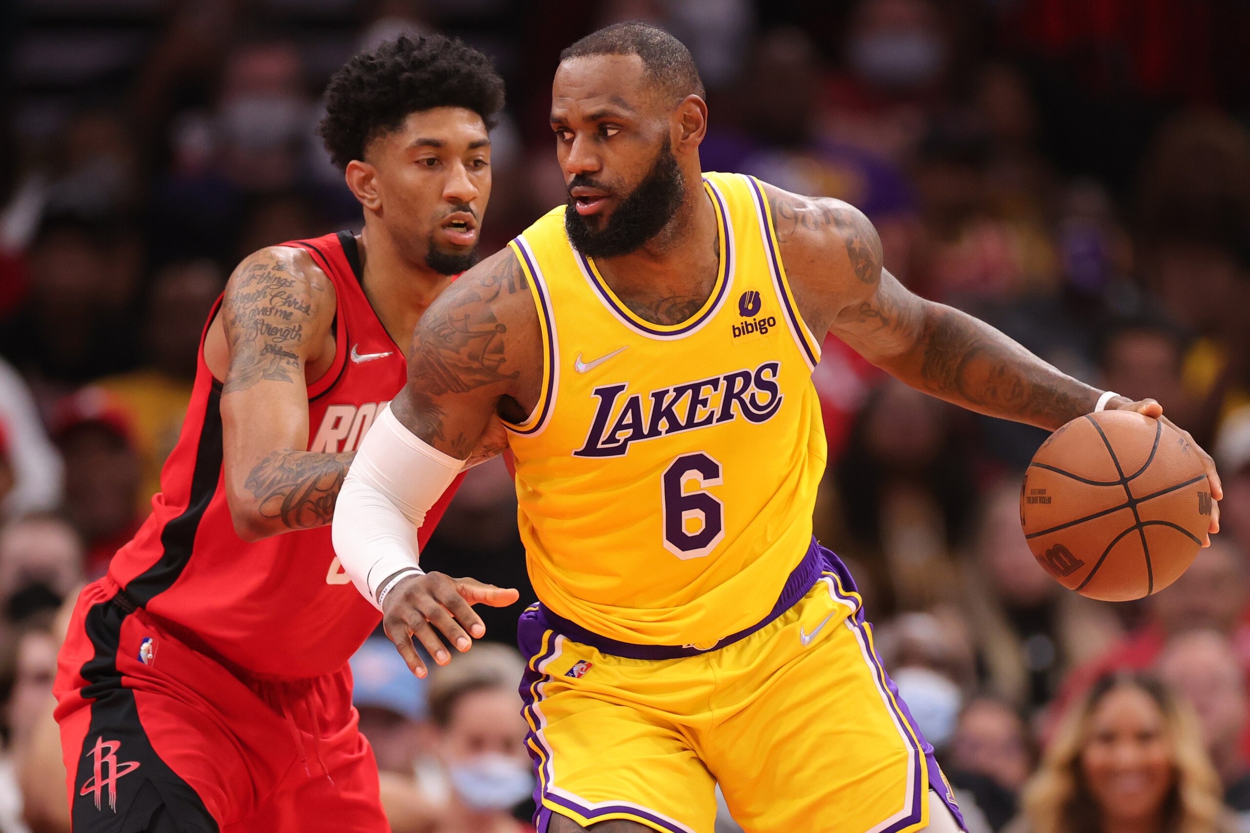 HOUSTON, TEXAS - DECEMBER 28: LeBron James #6 of the Los Angeles Lakers controls the ball ahead of Christian Wood #35 of the Houston Rockets during the first half at Toyota Center on December 28, 2021 in Houston, Texas. NOTE TO USER: User expressly acknowledges and agrees that, by downloading and or using this photograph, User is consenting to the terms and conditions of the Getty Images License Agreement. (Photo by Carmen Mandato/Getty Images)