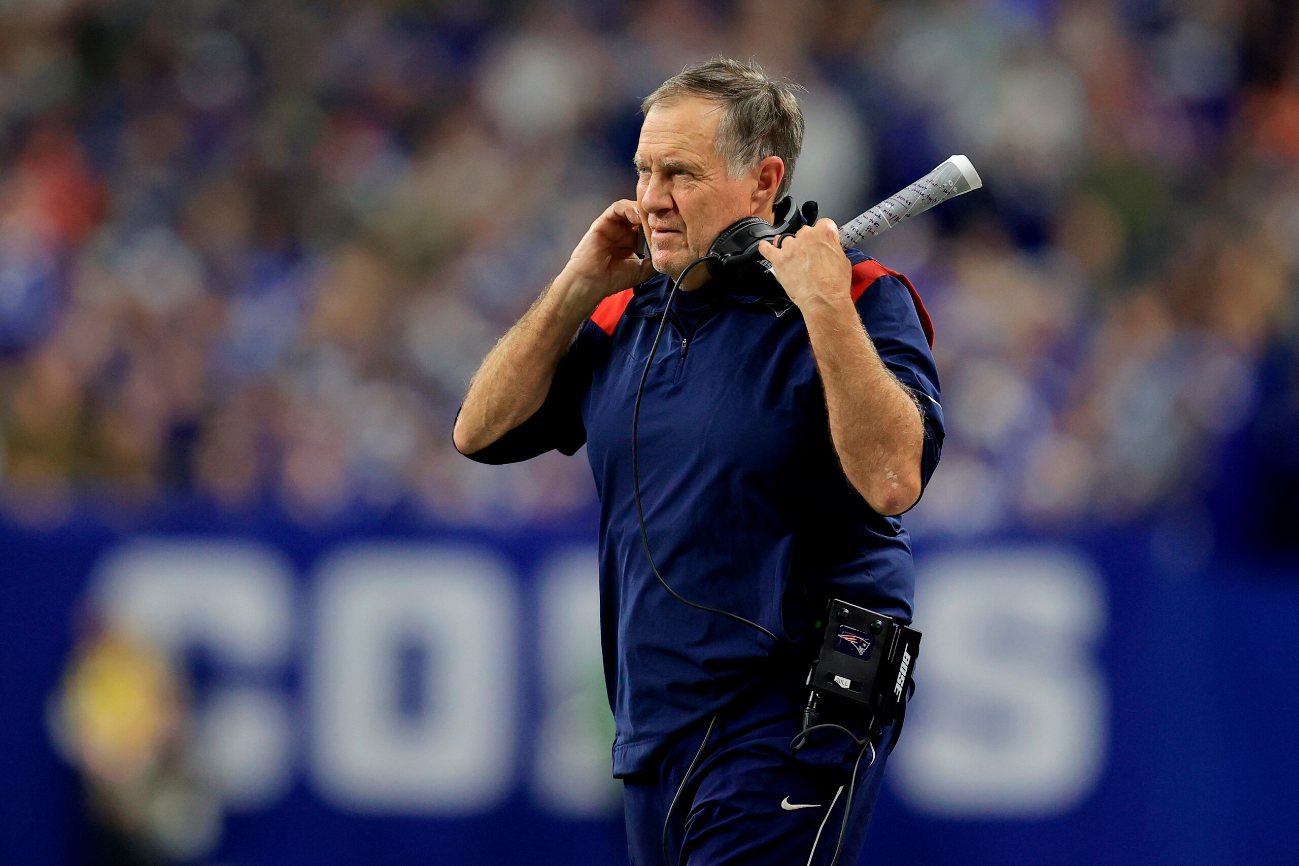 New England Patriots head coach Bill Belichick watches from the sidelines during the first half of an NFL football game against the Indianapolis Colts Saturday, Dec. 18, 2021, in Indianapolis. (AP Photo/Aaron Doster)