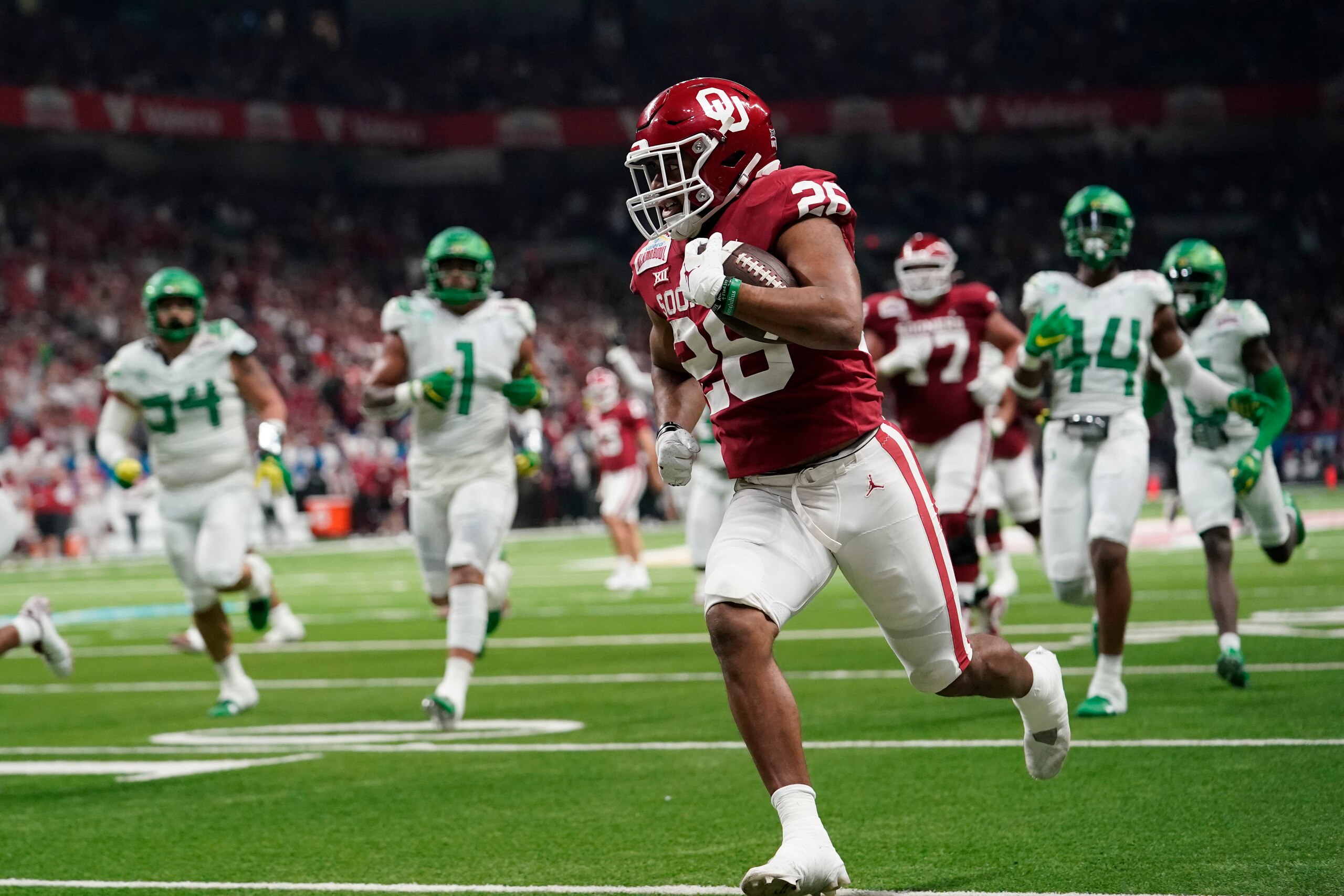 Oklahoma running back Kennedy Brooks (26) runs for a touchdown against Oregon during the first half of the Alamo Bowl NCAA college football game Wednesday, Dec. 29, 2021, in San Antonio. (AP Photo/Eric Gay)
