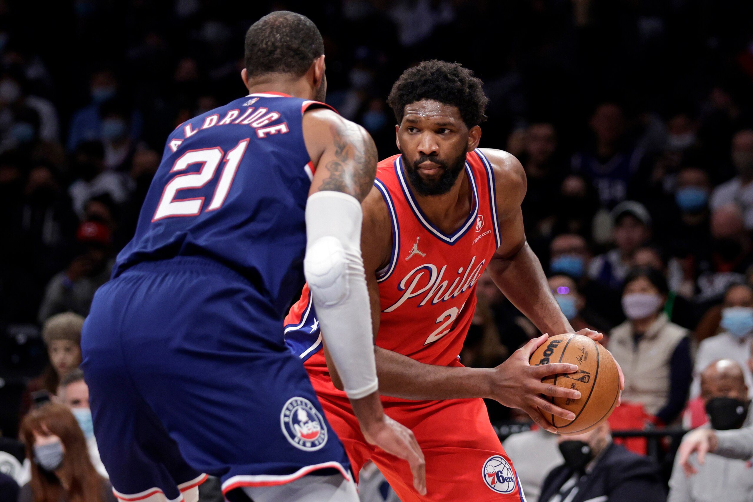 Philadelphia 76ers center Joel Embiid looks to drive against Brooklyn Nets center LaMarcus Aldridge (21) during the first half of an NBA basketball game Thursday, Dec. 30, 2021, in New York. (AP Photo/Adam Hunger)