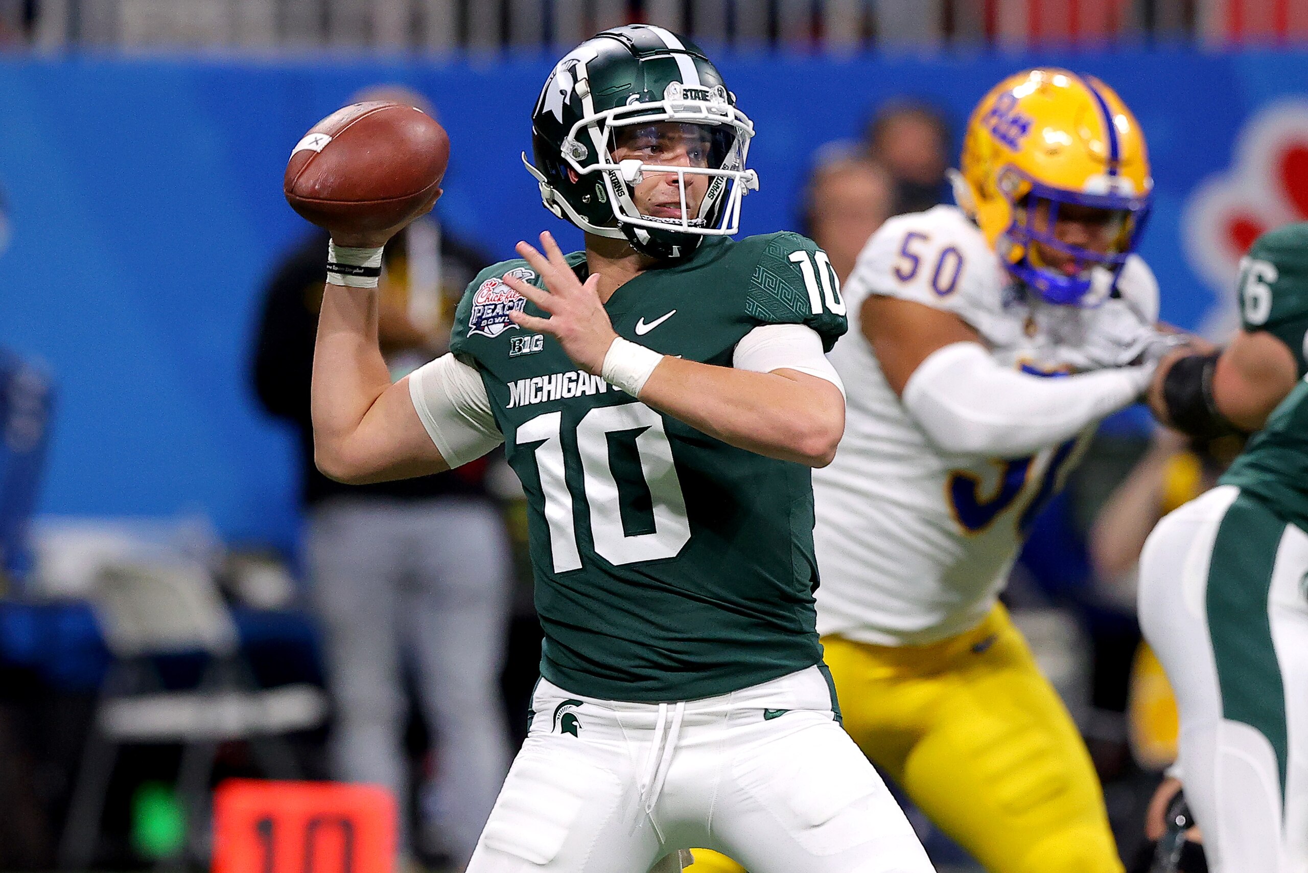 ATLANTA, GEORGIA - DECEMBER 30: Payton Thorne #10 of the Michigan State Spartans looks to pass the ball in the second quarter of the game against the Pittsburgh Panthers in the Chick-Fil-A Peach Bowl at Mercedes-Benz Stadium on December 30, 2021 in Atlanta, Georgia. (Photo by Todd Kirkland/Getty Images) ATLANTA, GEORGIA - DECEMBER 30: Payton Thorne #10 of the Michigan State Spartans looks to pass the ball in the second quarter of the game against the Pittsburgh Panthers in the Chick-Fil-A Peach Bowl at Mercedes-Benz Stadium on December 30, 2021 in Atlanta, Georgia. (Photo by Todd Kirkland/Getty Images)