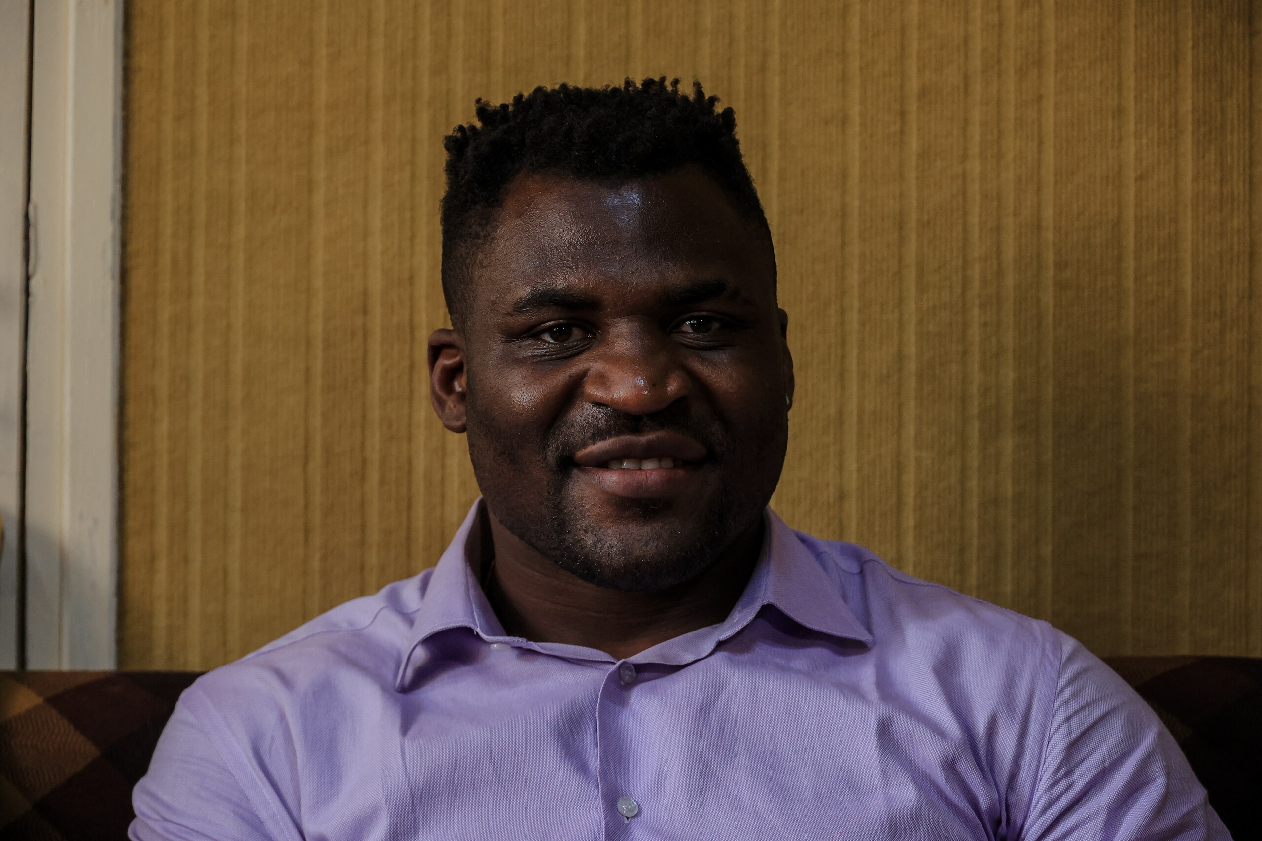 Cameroon's Francis Ngannou, world champion of heavyweight mixed martial arts (MMA), poses for a portrait in Bafoussam, Cameroon, on May 1, 2021. - Francis Ngannou, world champion of heavyweight mixed martial arts (MMA), made a triumphant return to his native village of Batié, in western Cameroon, on May 1, 2021.
Nicknamed "The Predator", he defeated American titleholder Stipe Miocic by knockout on March 28, becoming the first African to win the world title in the most prestigious league, the American Ultimate Fighting Championship (UFC). (Photo by Daniel Beloumou Olomo / AFP) (Photo by DANIEL BELOUMOU OLOMO/AFP via Getty Images)