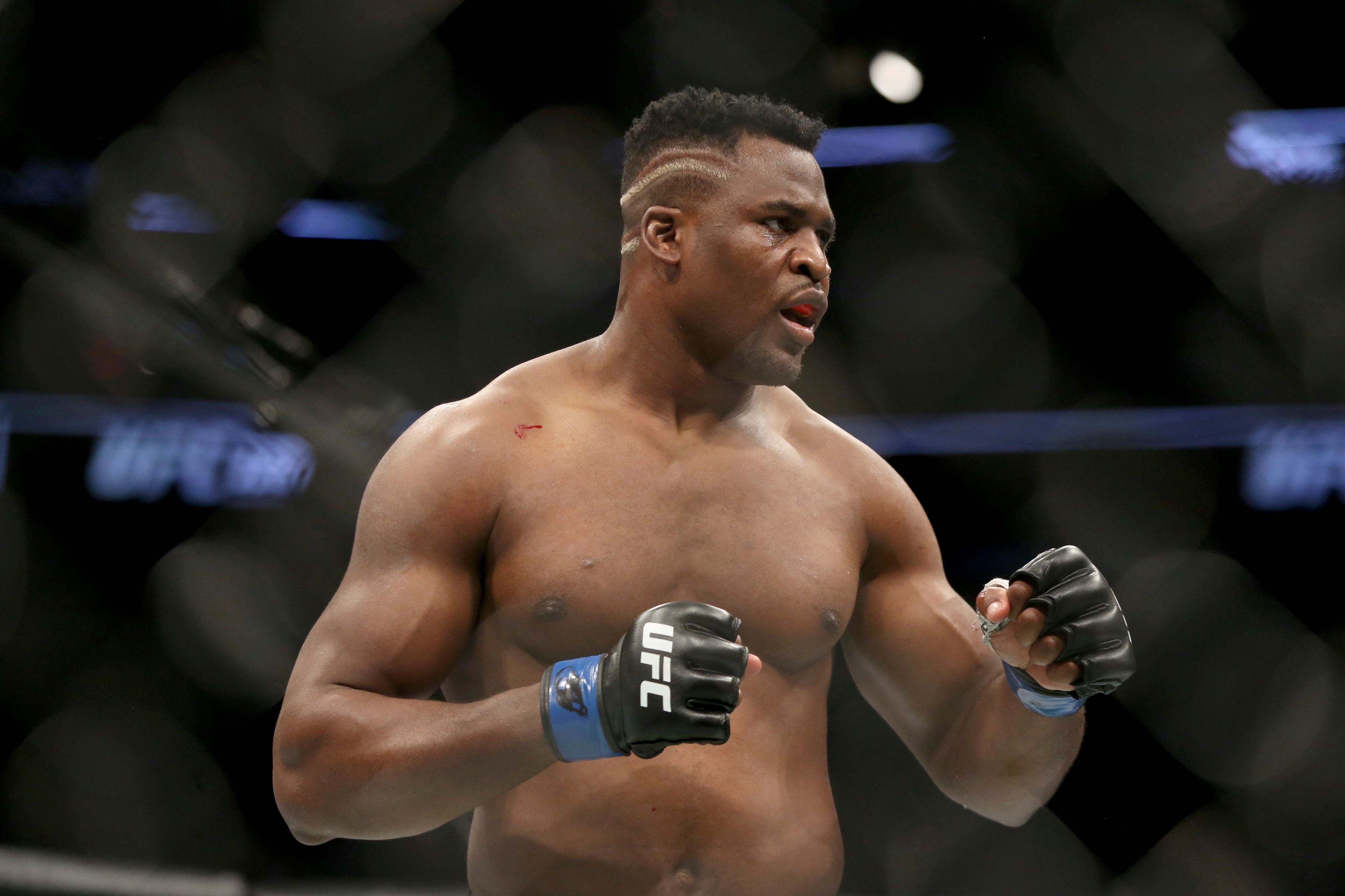 Francis Ngannou in action against Stipe Miocic during a heavyweight championship mixed martial arts bout at UFC 220, Sunday, Jan. 21, 2018, in Boston. Miocic retained his title via unanimous decision. (AP Photo/Gregory Payan)
