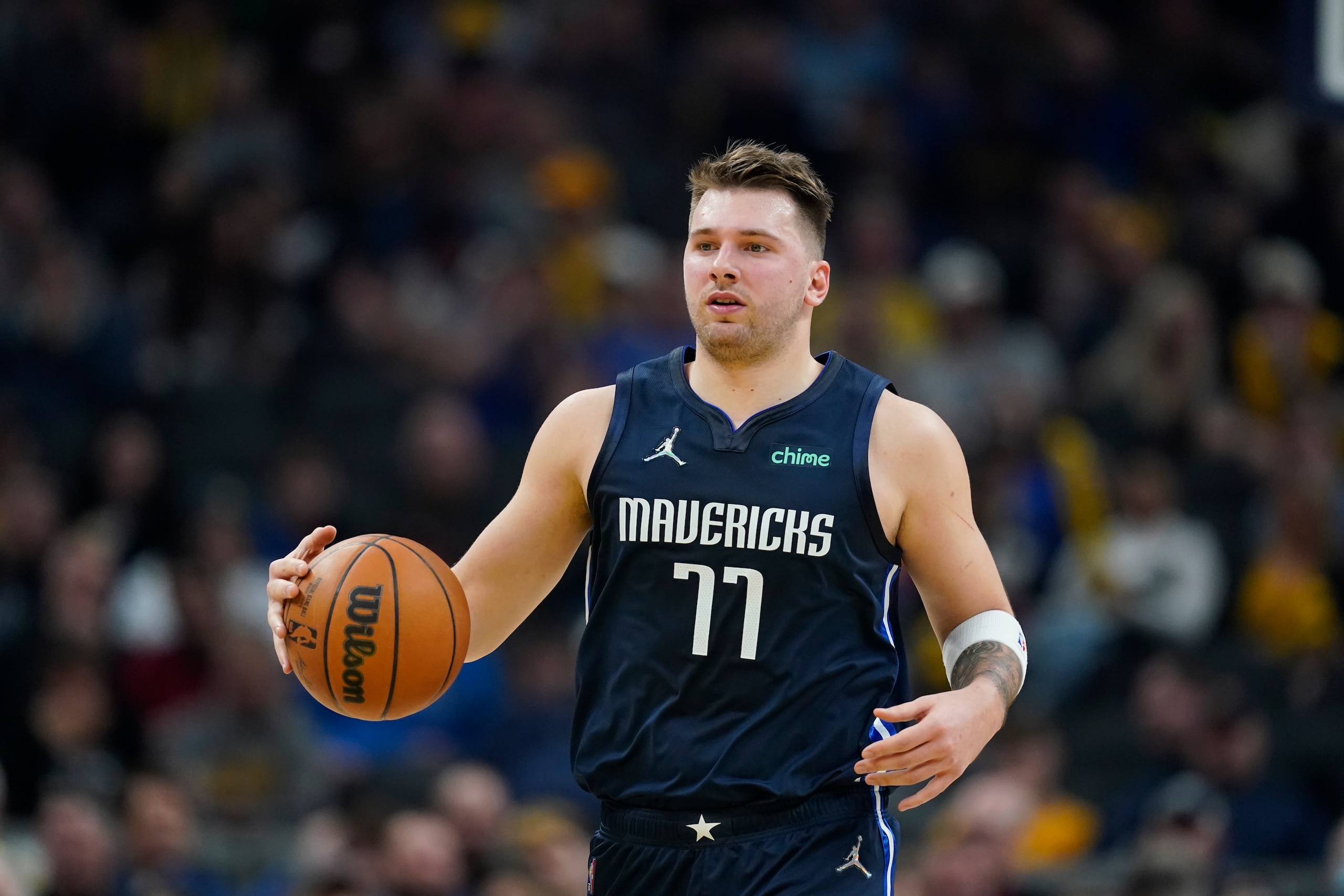 Dallas Mavericks' Luka Doncic (77) dribbles during the first half of an NBA basketball game against the Indiana Pacers, Friday, Dec. 10, 2021, in Indianapolis. (AP Photo/Darron Cummings)