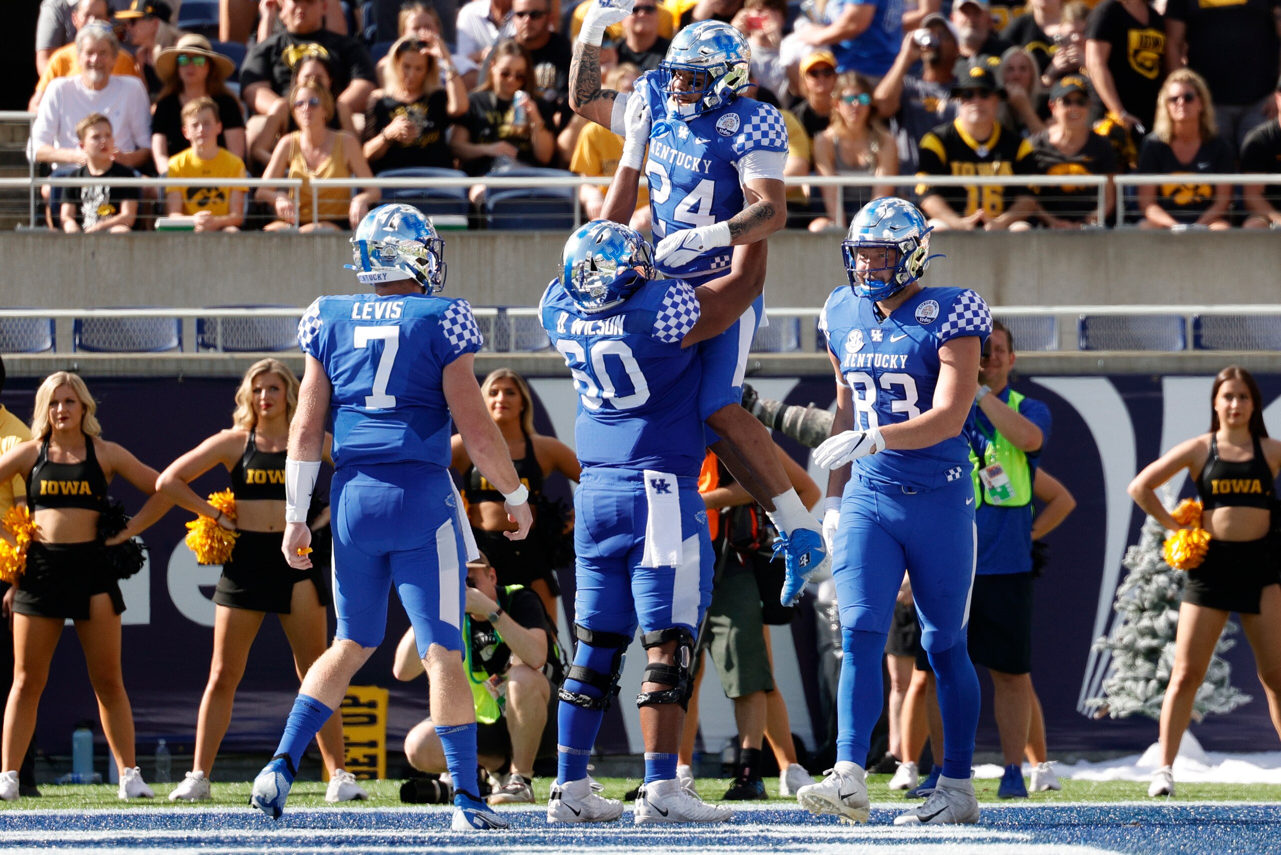 ORLANDO, FLORIDA - JANUARY 01: Chris Rodriguez Jr. #24 of the Kentucky Wildcats celebrates with this teammates after scoring a touchdown during the first quarter against the Iowa Hawkeyes in the Citrus Bowl at Camping World Stadium on January 01, 2022 in Orlando, Florida. (Photo by Douglas P. DeFelice/Getty Images)