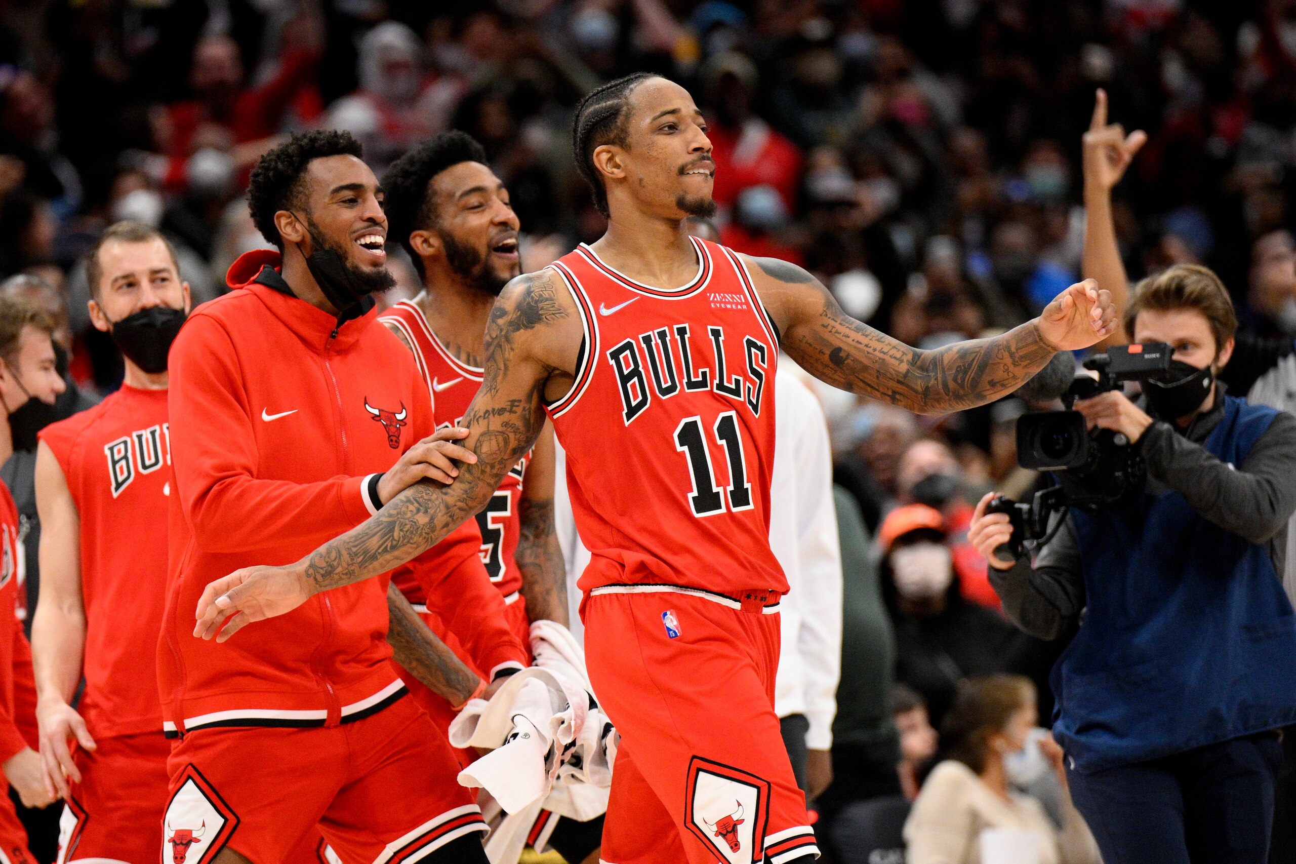 Chicago Bulls forward DeMar DeRozan (11) reacts with teammates after he made a three-point basket at the buzzer at the end of an NBA basketball game against the Washington Wizards, Saturday, Jan. 1, 2022, in Washington. The Bulls won 120-119. (AP Photo/Nick Wass)