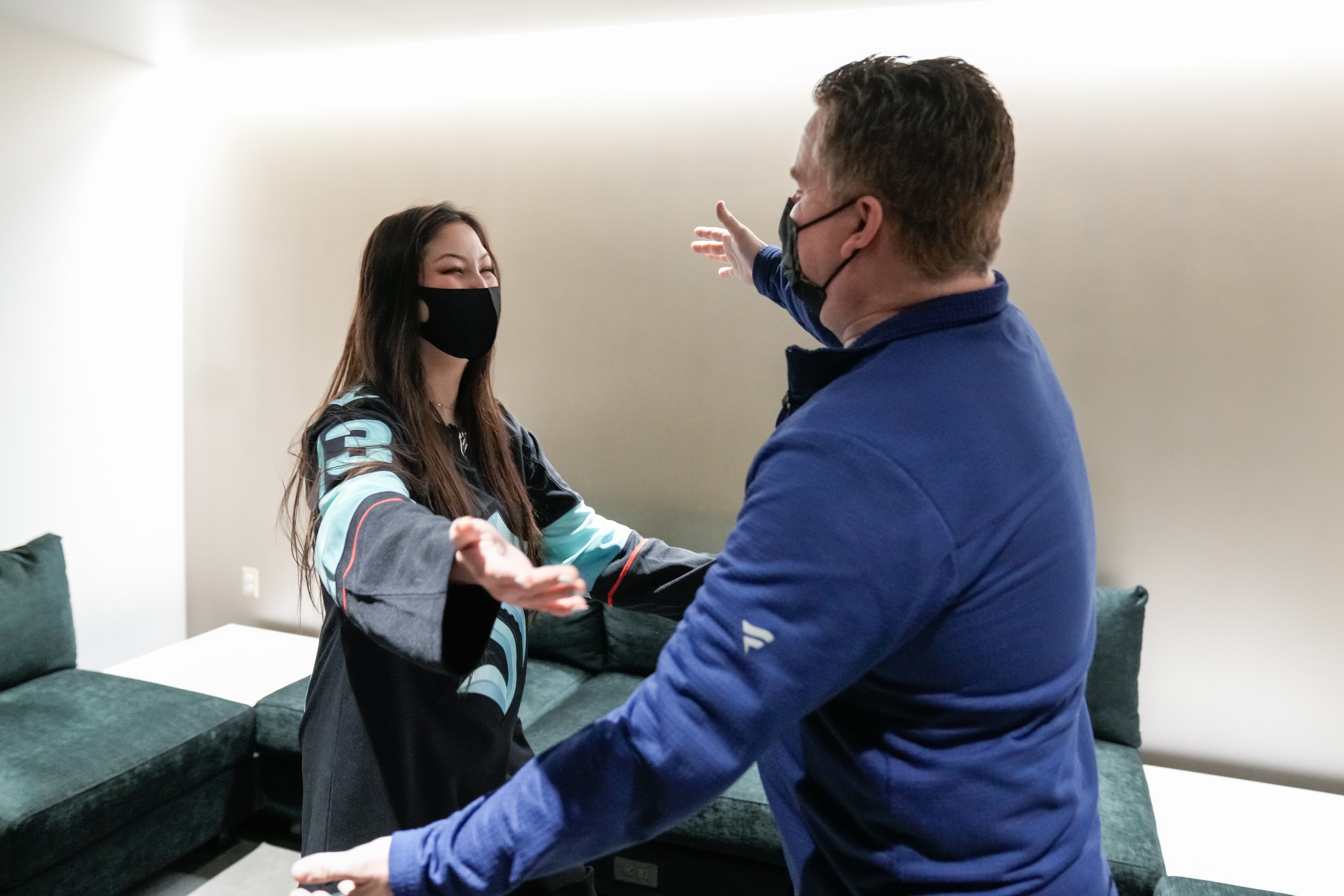 SEATTLE, WASHINGTON - JANUARY 01: Seattle Kraken fan Nadia Popovici and Vancouver Canucks equipment manager Brian Hamilton meet before the game at Climate Pledge Arena on January 01, 2022 in Seattle, Washington. Popovici made headlines by alerting Hamilton at a previous game between the teams on October 23rd of a cancerous mole. (Photo by Christopher Mast/NHLI via Getty Images)