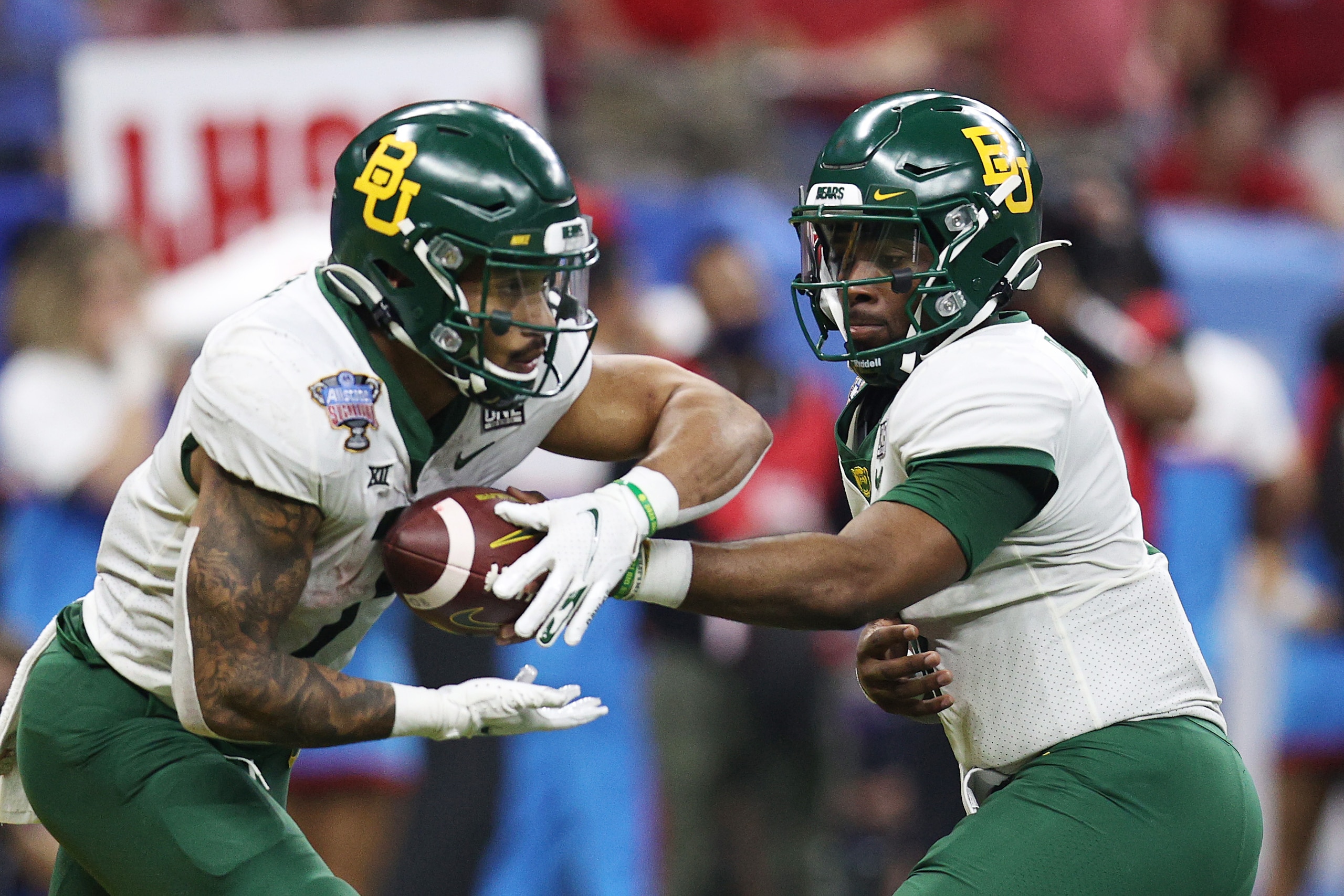 NEW ORLEANS, LOUISIANA - JANUARY 01: Gerry Bohanon #11 of the Baylor Bears hands the ball off to \a in the Allstate Sugar Bowl at Caesars Superdome on January 01, 2022 in New Orleans, Louisiana. (Photo by Sean Gardner/Getty Images)