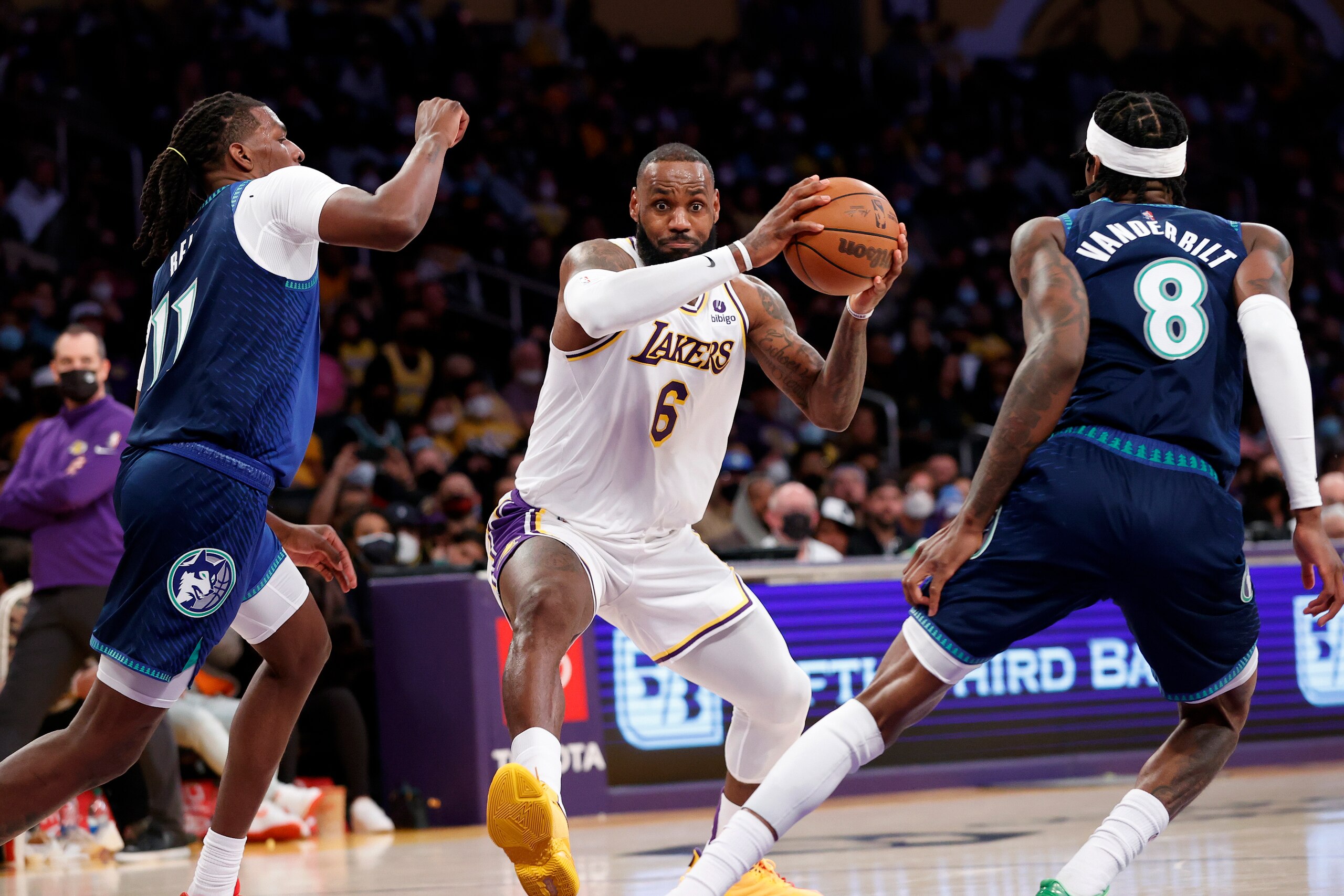 Los Angeles Lakers forward LeBron James (6) drives between Minnesota Timberwolves center Naz Reid (11) and Jarred Vanderbilt (8) during the first half of an NBA basketball game in Los Angeles, Sunday, Jan. 2, 2022. (AP Photo/Ringo H.W. Chiu) Los Angeles Lakers forward LeBron James (6) drives between Minnesota Timberwolves center Naz Reid (11) and Jarred Vanderbilt (8) during the first half of an NBA basketball game in Los Angeles, Sunday, Jan. 2, 2022. (AP Photo/Ringo H.W. Chiu)