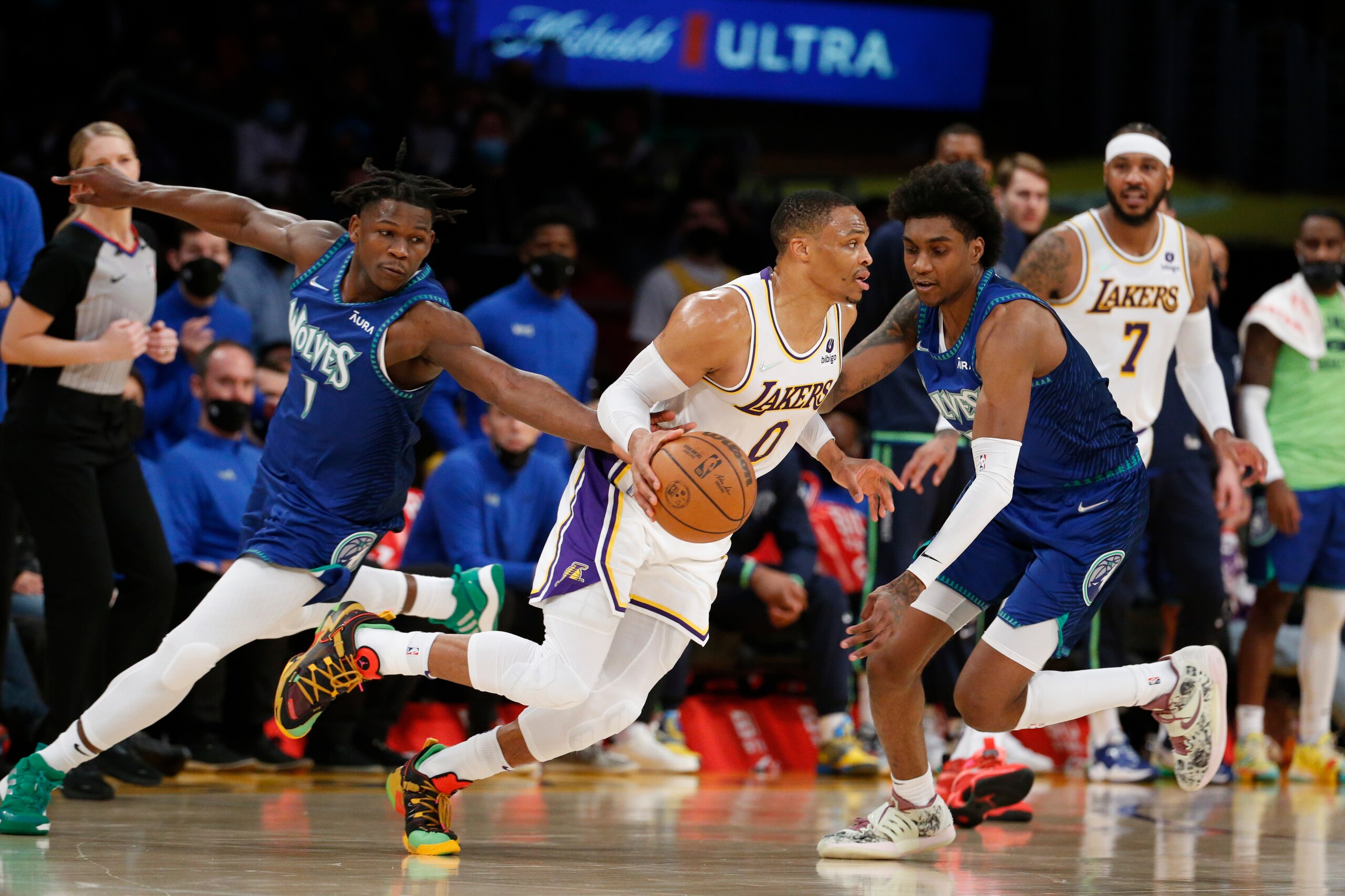Los Angeles Lakers guard Russell Westbrook (0) drives between Minnesota Timberwolves forwards Anthony Edwards (1) and Jaden McDaniels (3) during the second half of an NBA basketball game in Los Angeles, Sunday, Jan. 2, 2022. The Laker won 108-103. (AP Photo/Ringo H.W. Chiu)