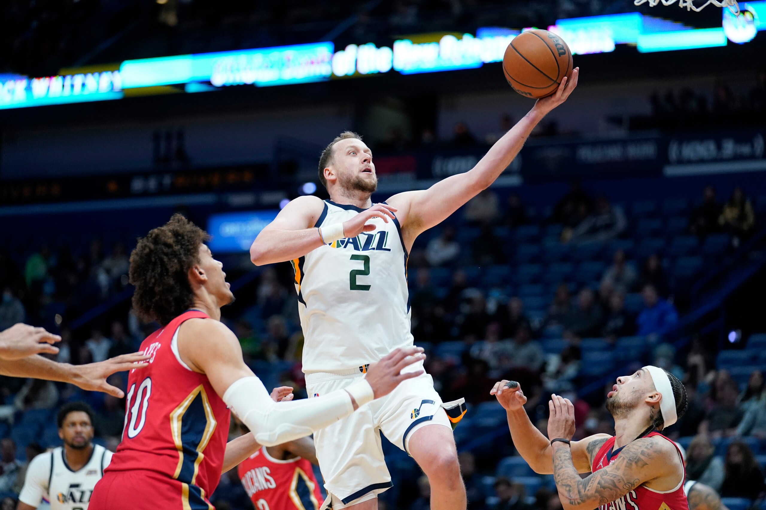 Utah Jazz guard Joe Ingles (2) goes to the basket between New Orleans Pelicans center Jaxson Hayes (10) and guard Jose Alvarado in the second half of an NBA basketball game in New Orleans, Monday, Jan. 3, 2022. The Jazz won 115-104. (AP Photo/Gerald Herbert)