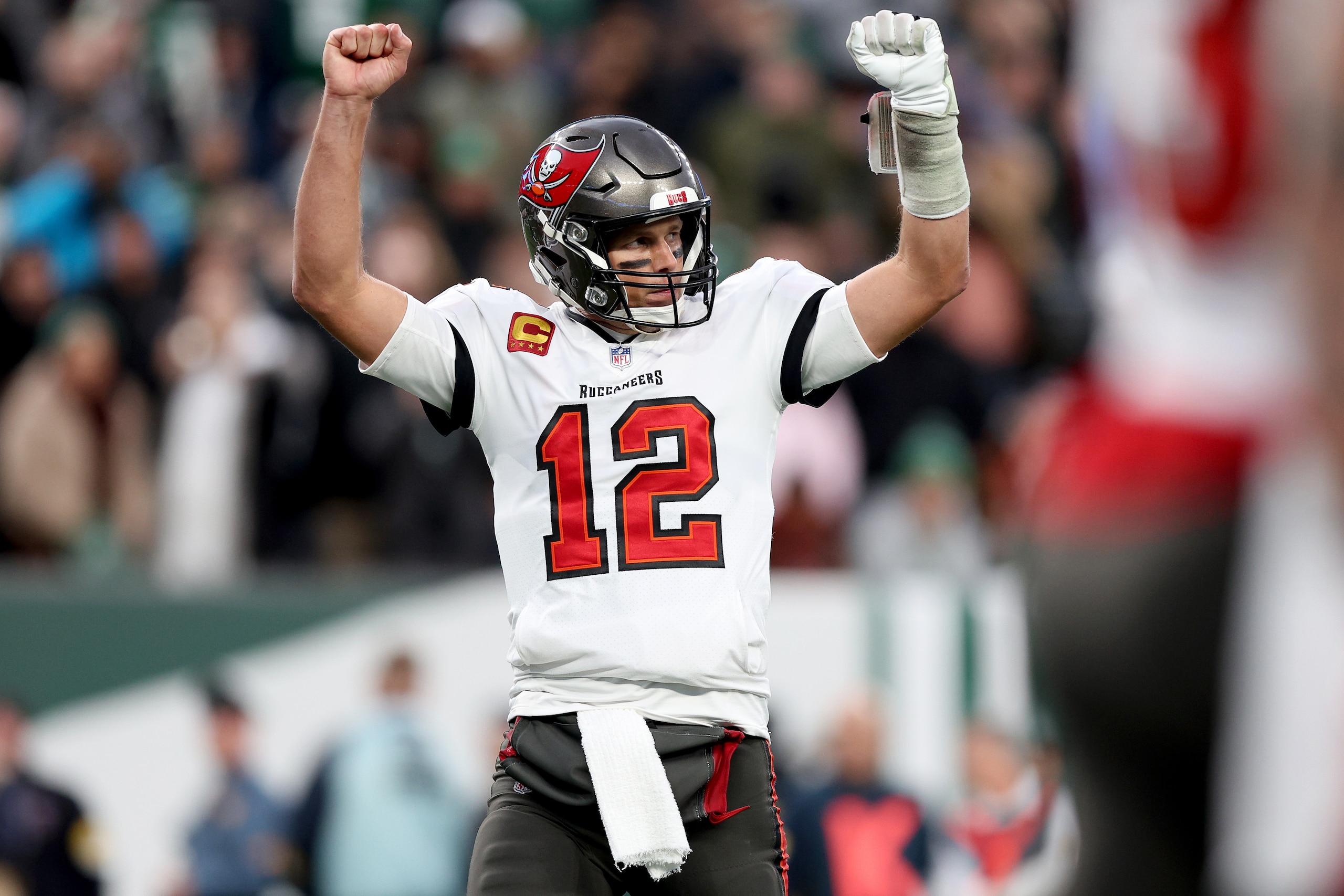 EAST RUTHERFORD, NEW JERSEY - JANUARY 02:  Tom Brady #12 of the Tampa Bay Buccaneers celebrates a successful two-point conversion in the fourth quarter of the game against the New York Jets at MetLife Stadium on January 02, 2022 in East Rutherford, New Jersey. (Photo by Elsa/Getty Images)