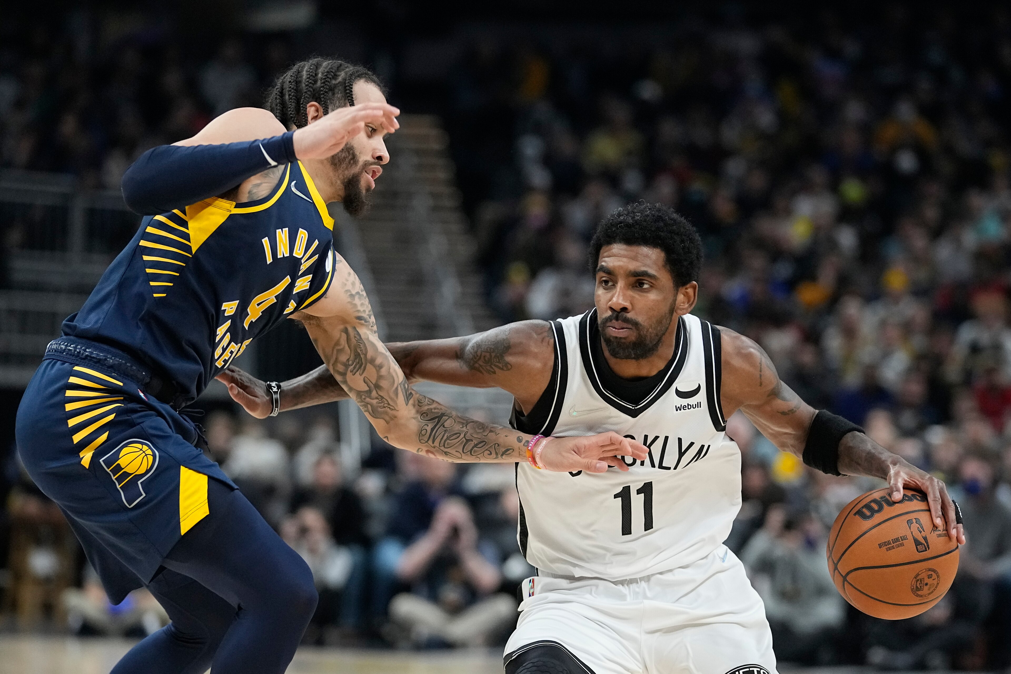 Brooklyn Nets' Kyrie Irving (11) is defended by Indiana Pacers' Duane Washington Jr. (4) during the first half of an NBA basketball game Wednesday, Jan. 5, 2022, in Indianapolis. (AP Photo/Darron Cummings) Brooklyn Nets' Kyrie Irving (11) is defended by Indiana Pacers' Duane Washington Jr. (4) during the first half of an NBA basketball game Wednesday, Jan. 5, 2022, in Indianapolis. (AP Photo/Darron Cummings)