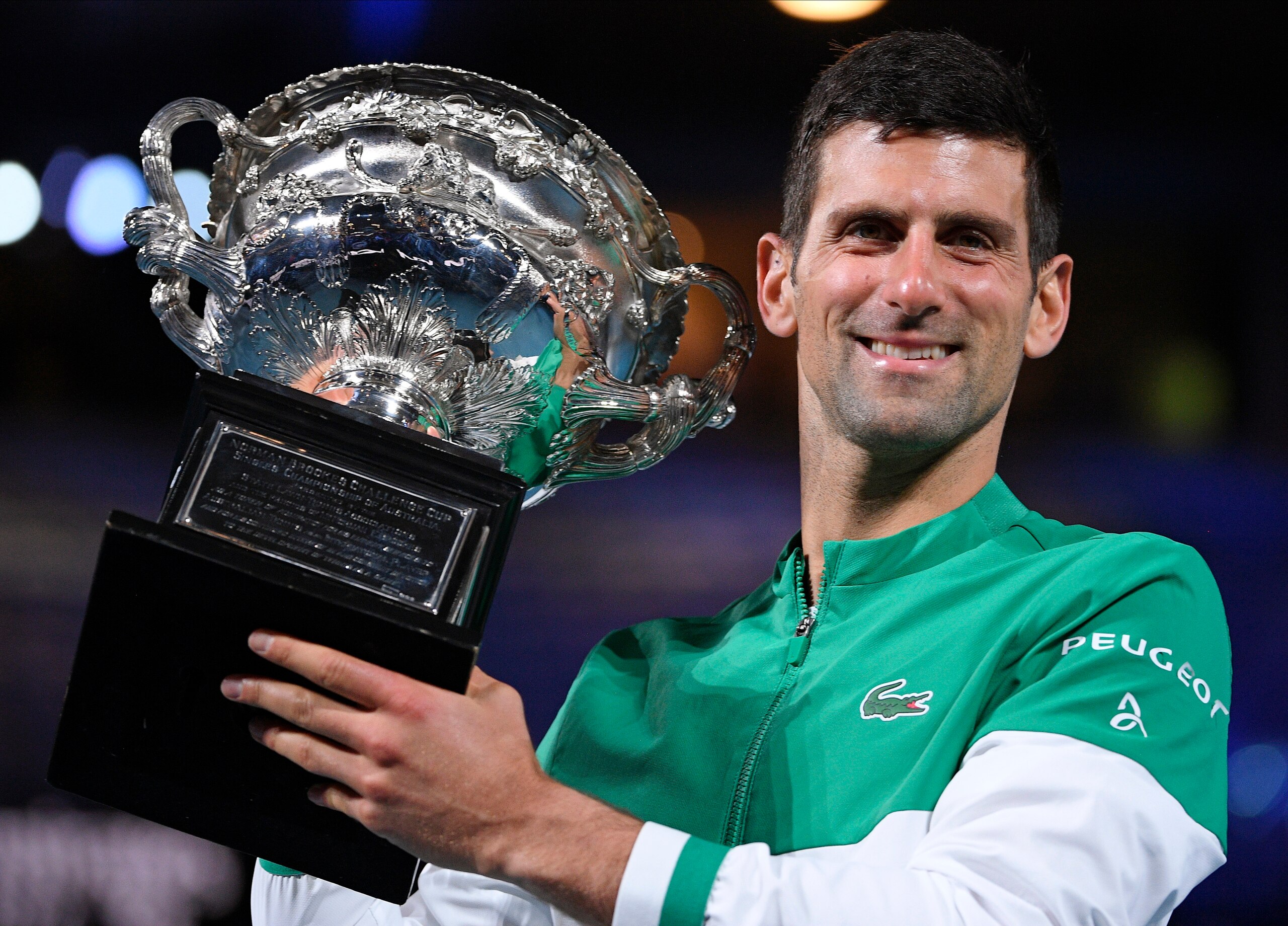 FILE - Serbia's Novak Djokovic holds the Norman Brookes Challenge Cup after defeating Russia's Daniil Medvedev in the men's singles final at the Australian Open tennis championship in Melbourne, Australia, Sunday, Feb. 21, 2021. Djokovic has had his visa canceled and been denied entry to Australia, Thursday, Jan. 6, 2022 and is set to be removed from the country after spending the night at the Melbourne airport as officials refused to let him enter the country for the Australian Open after an apparent visa mix-up.(AP Photo/Andy Brownbill, File) FILE - Serbia's Novak Djokovic holds the Norman Brookes Challenge Cup after defeating Russia's Daniil Medvedev in the men's singles final at the Australian Open tennis championship in Melbourne, Australia, Sunday, Feb. 21, 2021. Djokovic has had his visa canceled and been denied entry to Australia, Thursday, Jan. 6, 2022 and is set to be removed from the country after spending the night at the Melbourne airport as officials refused to let him enter the country for the Australian Open after an apparent visa mix-up.(AP Photo/Andy Brownbill, File)