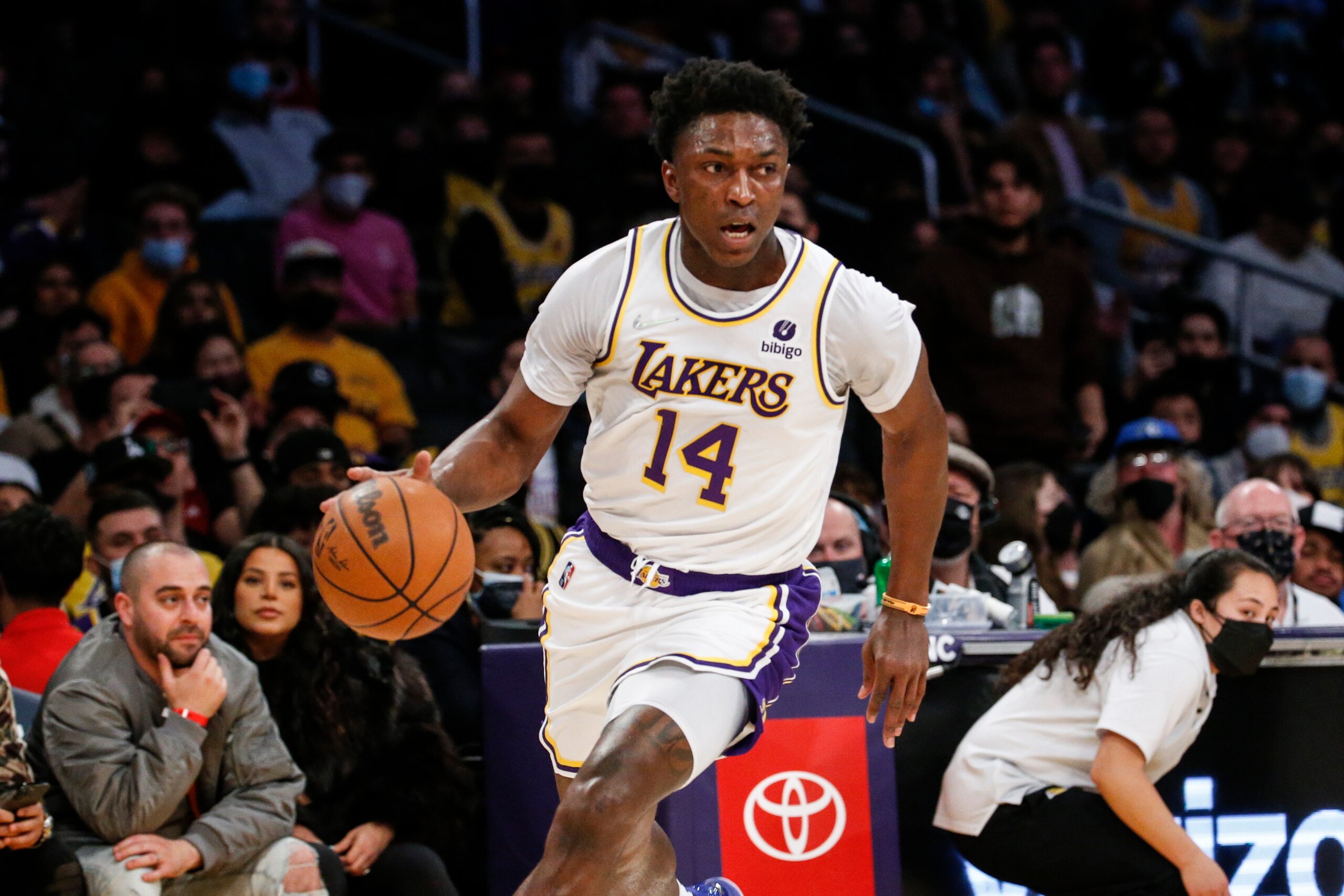 Los Angeles Lakers forward Stanley Johnson (14) drives against the Minnesota Timberwolves during the first half of an NBA basketball game in Los Angeles, Sunday, Jan. 2, 2022. (AP Photo/Ringo H.W. Chiu)