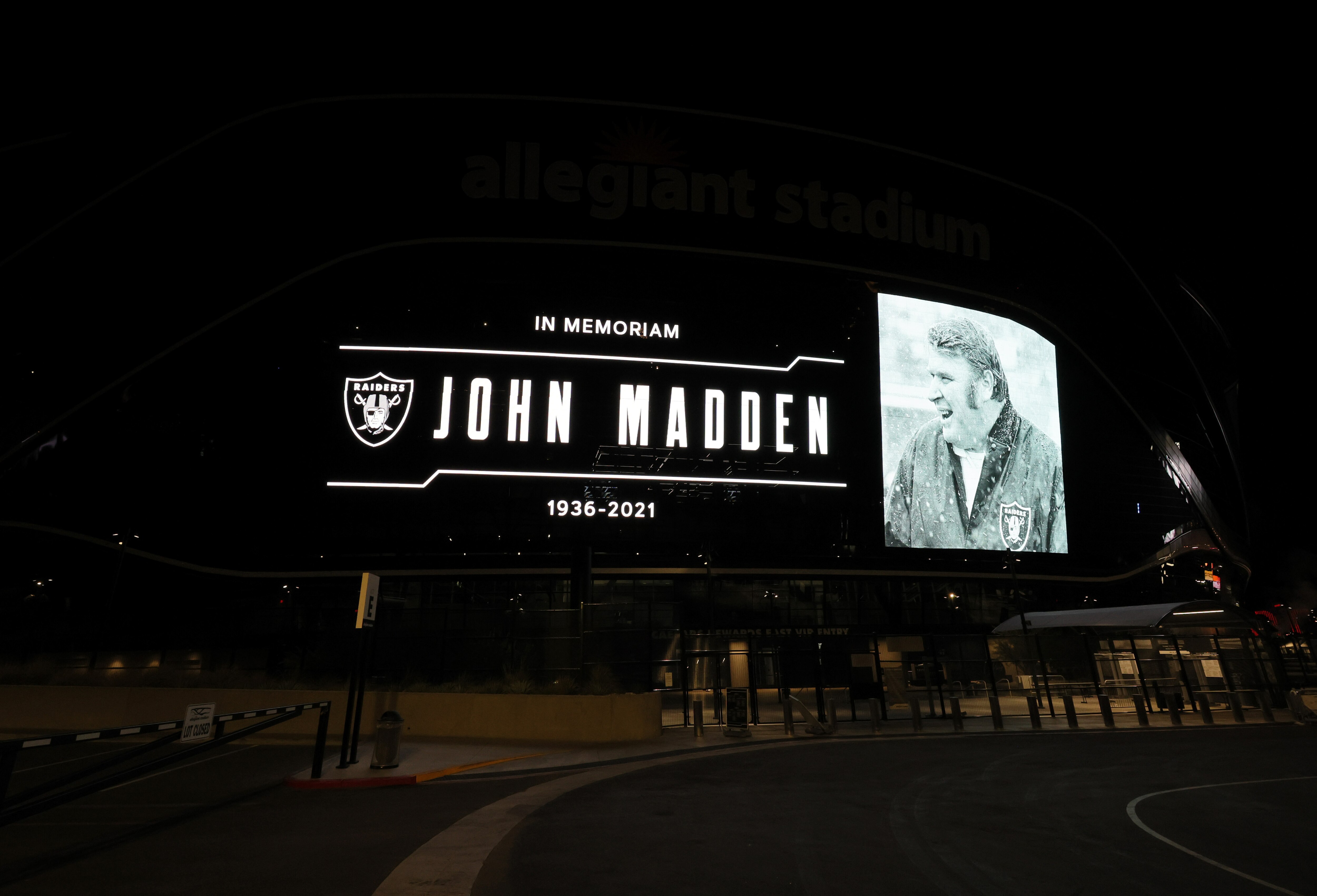 LAS VEGAS, NEVADA - DECEMBER 28: A tribute to former Raiders head coach, Pro Football Hall of Fame member and broadcaster John Madden is displayed on the side of Allegiant Stadium, home of the Las Vegas Raiders, after news of his death at the age of 85 on December 28, 2021 in Las Vegas, Nevada. Madden coached the Oakland Raiders for 10 seasons and won the team's first championship with a win over the Minnesota Vikings in Super Bowl XI in 1977. Owner and managing general partner Mark Davis of the Las Vegas Raiders lit the Al Davis Memorial Torch inside the stadium before the organization turned off all the exterior lights, except for the memorial message, in honor of Madden. (Photo by Ethan Miller/Getty Images) LAS VEGAS, NEVADA - DECEMBER 28: A tribute to former Raiders head coach, Pro Football Hall of Fame member and broadcaster John Madden is displayed on the side of Allegiant Stadium, home of the Las Vegas Raiders, after news of his death at the age of 85 on December 28, 2021 in Las Vegas, Nevada. Madden coached the Oakland Raiders for 10 seasons and won the team's first championship with a win over the Minnesota Vikings in Super Bowl XI in 1977. Owner and managing general partner Mark Davis of the Las Vegas Raiders lit the Al Davis Memorial Torch inside the stadium before the organization turned off all the exterior lights, except for the memorial message, in honor of Madden. (Photo by Ethan Miller/Getty Images)