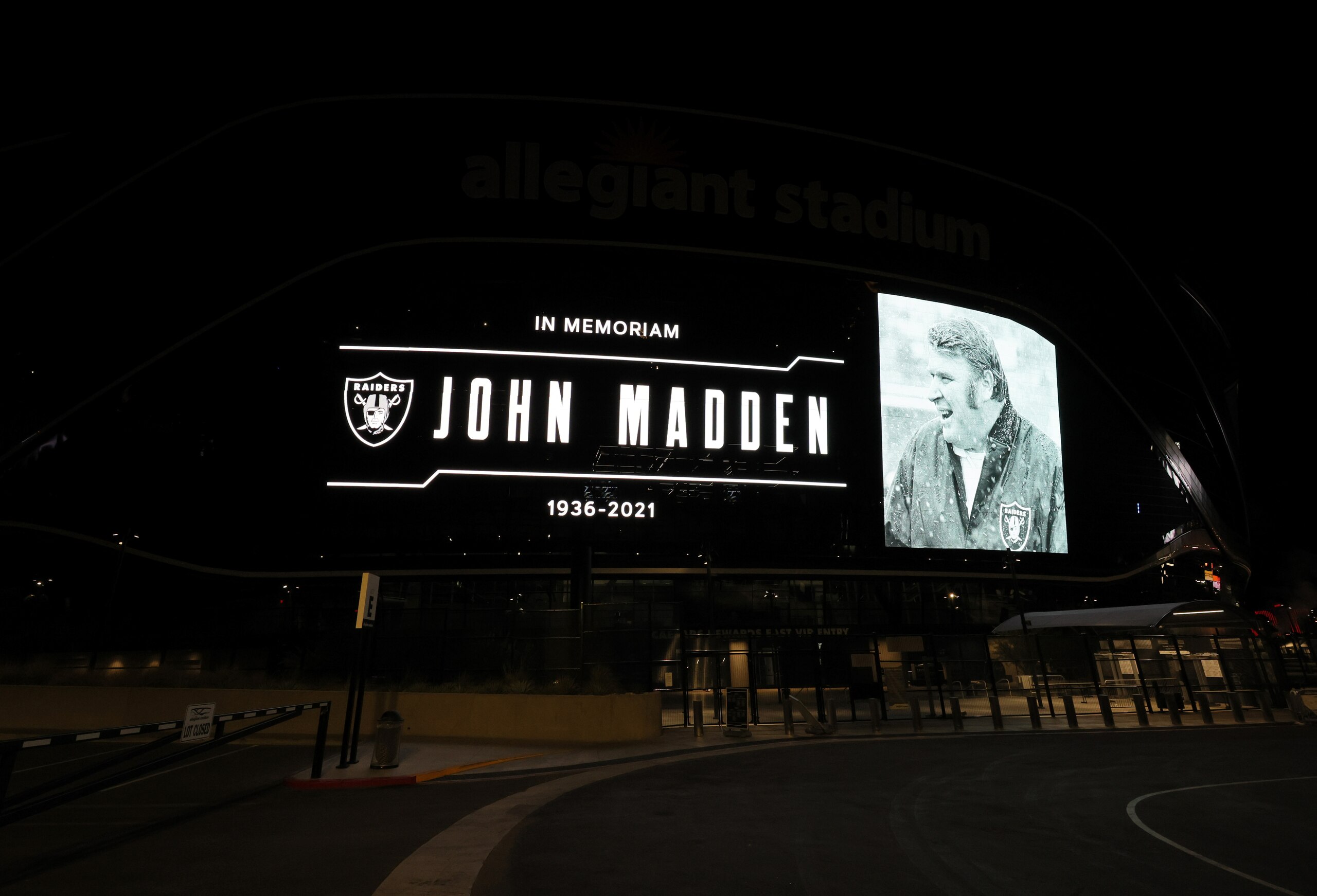 LAS VEGAS, NEVADA - DECEMBER 28: A tribute to former Raiders head coach, Pro Football Hall of Fame member and broadcaster John Madden is displayed on the side of Allegiant Stadium, home of the Las Vegas Raiders, after news of his death at the age of 85 on December 28, 2021 in Las Vegas, Nevada. Madden coached the Oakland Raiders for 10 seasons and won the team's first championship with a win over the Minnesota Vikings in Super Bowl XI in 1977. Owner and managing general partner Mark Davis of the Las Vegas Raiders lit the Al Davis Memorial Torch inside the stadium before the organization turned off all the exterior lights, except for the memorial message, in honor of Madden. (Photo by Ethan Miller/Getty Images) LAS VEGAS, NEVADA - DECEMBER 28: A tribute to former Raiders head coach, Pro Football Hall of Fame member and broadcaster John Madden is displayed on the side of Allegiant Stadium, home of the Las Vegas Raiders, after news of his death at the age of 85 on December 28, 2021 in Las Vegas, Nevada. Madden coached the Oakland Raiders for 10 seasons and won the team's first championship with a win over the Minnesota Vikings in Super Bowl XI in 1977. Owner and managing general partner Mark Davis of the Las Vegas Raiders lit the Al Davis Memorial Torch inside the stadium before the organization turned off all the exterior lights, except for the memorial message, in honor of Madden. (Photo by Ethan Miller/Getty Images)