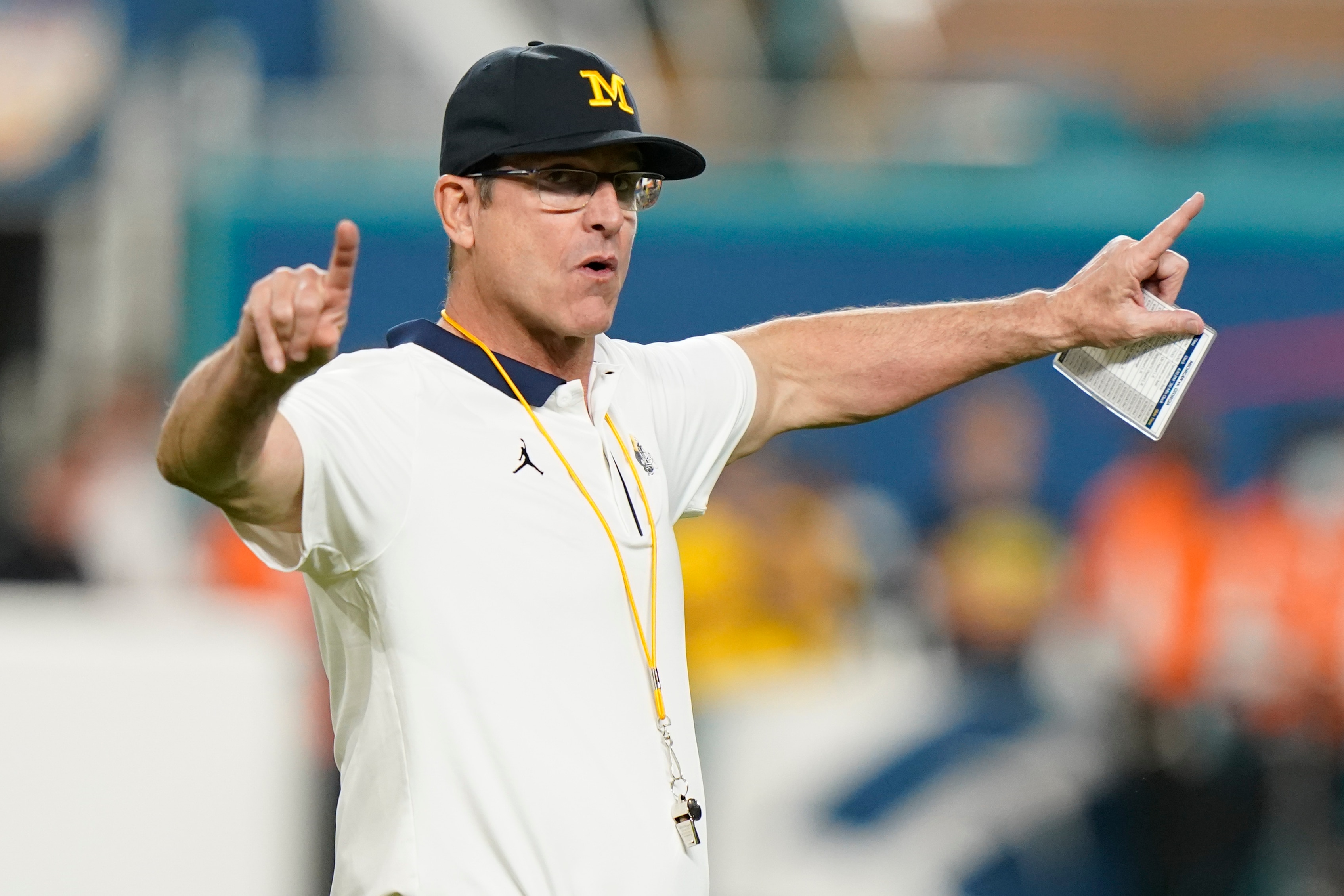 Michigan head coach Jim Harbaugh yells during warm ups before the Orange Bowl NCAA College Football Playoff semifinal game against Georgia, Friday, Dec. 31, 2021, in Miami Gardens, Fla.(AP Photo/Lynne Sladky)
