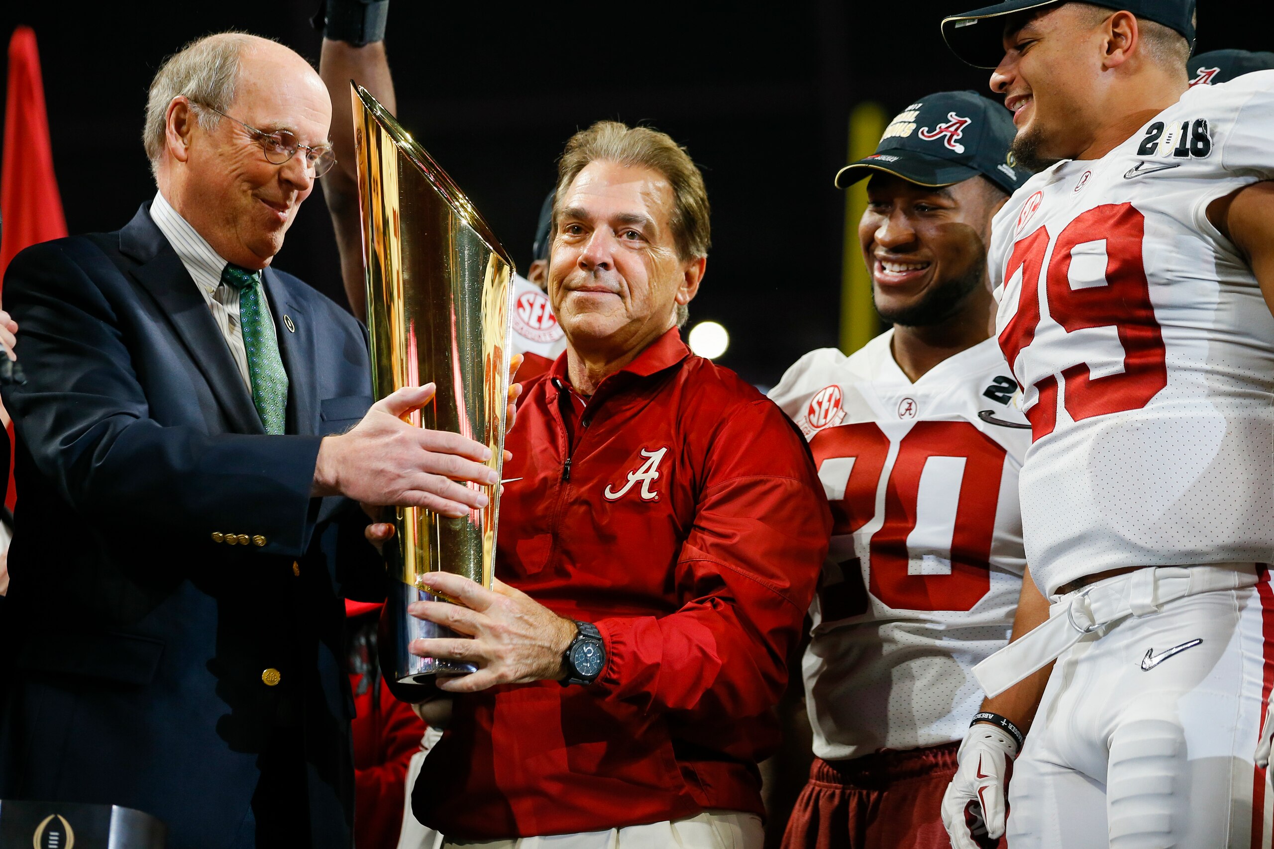 ATLANTA, GA - JANUARY 08: Alabama Crimson Tide head coach Nick Saban receives the CFP trophy during the trophy presentation at the conclusion of the College Football Playoff National Championship Game between the Alabama Crimson Tide and the Georgia Bulldogs on January 8, 2018 at Mercedes-Benz Stadium in Atlanta, GA. The Alabama Crimson Tide won the game in overtime 26-23. (Photo by Todd Kirkland/Icon Sportswire via Getty Images) ATLANTA, GA - JANUARY 08: Alabama Crimson Tide head coach Nick Saban receives the CFP trophy during the trophy presentation at the conclusion of the College Football Playoff National Championship Game between the Alabama Crimson Tide and the Georgia Bulldogs on January 8, 2018 at Mercedes-Benz Stadium in Atlanta, GA. The Alabama Crimson Tide won the game in overtime 26-23. (Photo by Todd Kirkland/Icon Sportswire via Getty Images)