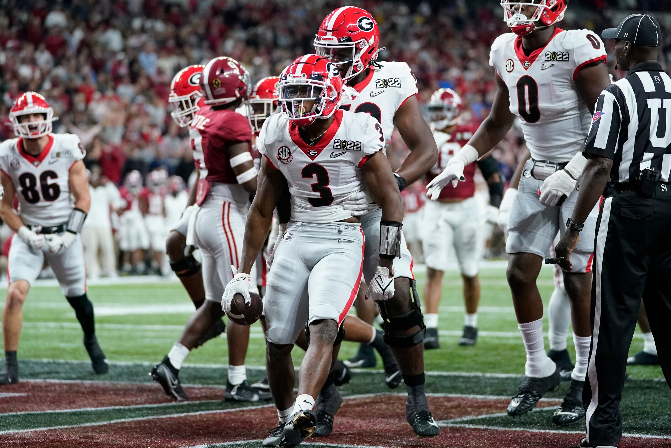 Georgia's Zamir White celebrates after running for a touchdown during the second half of the College Football Playoff championship football game against Alabama Monday, Jan. 10, 2022, in Indianapolis. (AP Photo/Paul Sancya)