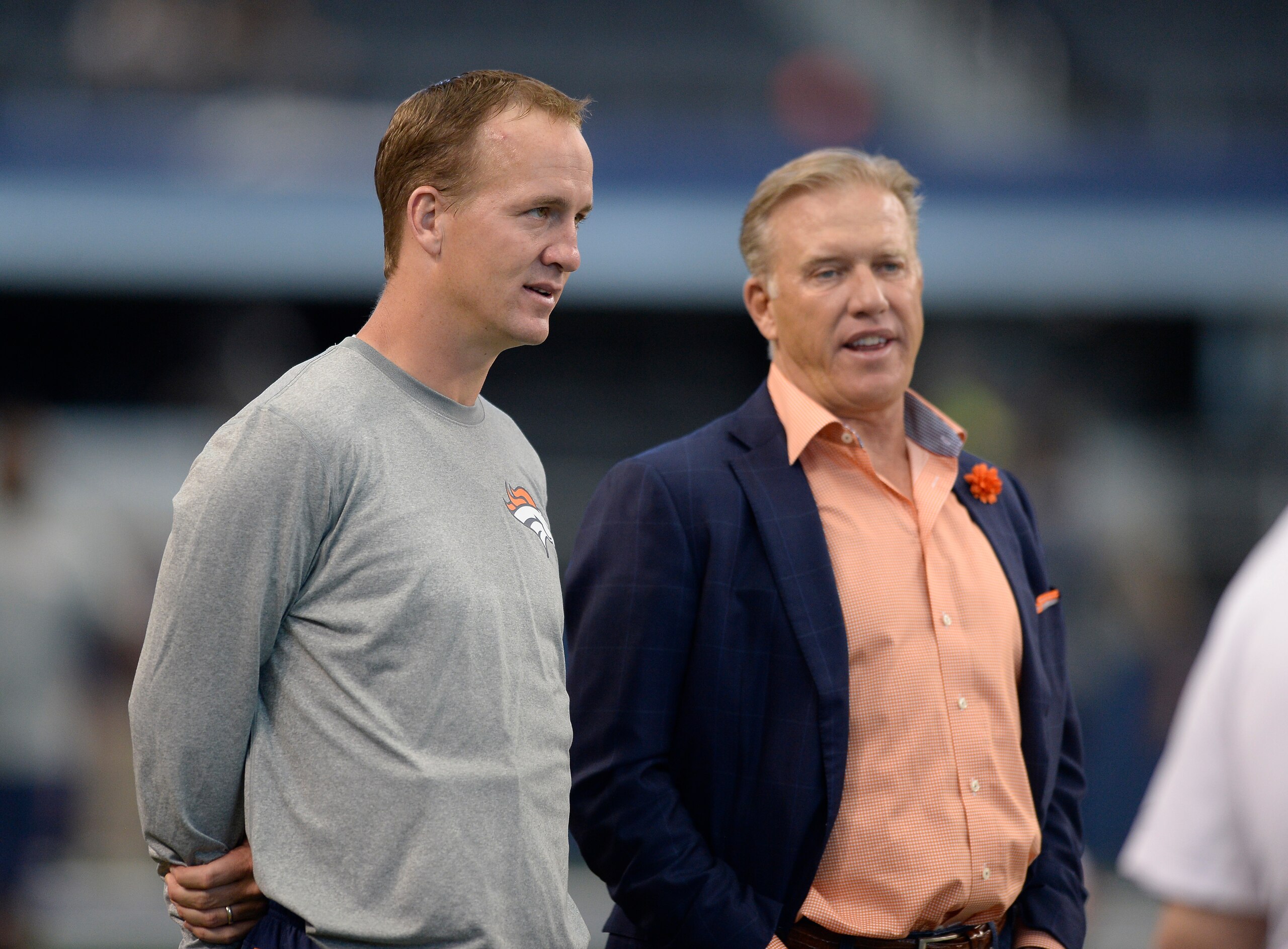 ARLINGTON, TX - AUGUST 28: Denver Broncos quarterback Peyton Manning talks with Denver Broncos General Manager and Executive Vice President of Football Operations John Elway during the teams warmups before their game against the Dallas Cowboys August 28, 2014 at AT&T Stadium. (Photo by John Leyba/The Denver Post via Getty Images)