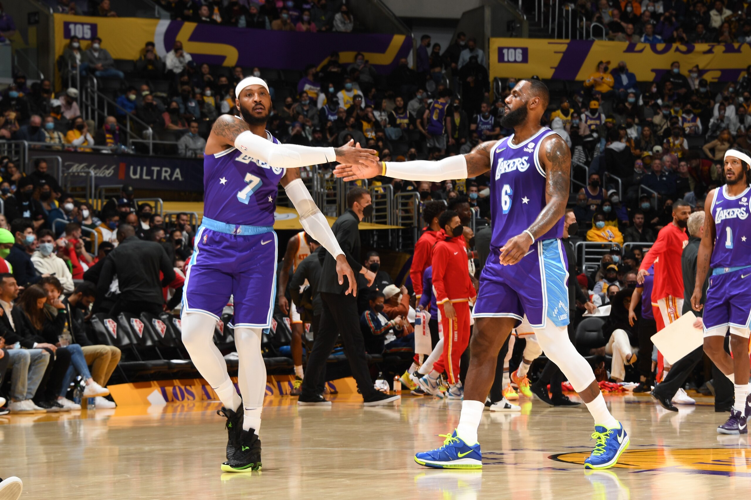 LOS ANGELES, CA - JANUARY 7: LeBron James #6 hi-fives Carmelo Anthony #7 of the Los Angeles Lakers during the game against the Atlanta Hawks on January 7, 2022 at Crypto.Com Arena in Los Angeles, California. NOTE TO USER: User expressly acknowledges and agrees that, by downloading and/or using this Photograph, user is consenting to the terms and conditions of the Getty Images License Agreement. Mandatory Copyright Notice: Copyright 2021 NBAE (Photo by Andrew D. Bernstein/NBAE via Getty Images)