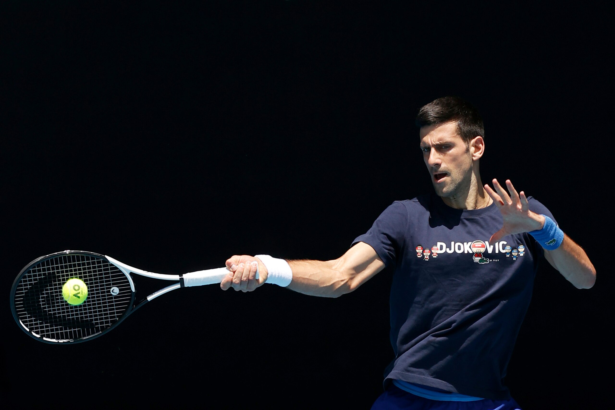 MELBOURNE, AUSTRALIA - JANUARY 12: Novak Djokovic of Serbia plays a forehand shot during a practice session ahead of the 2022 Australian Open at Melbourne Park on January 12, 2022 in Melbourne, Australia. (Photo by Darrian Traynor/Getty Images) MELBOURNE, AUSTRALIA - JANUARY 12: Novak Djokovic of Serbia plays a forehand shot during a practice session ahead of the 2022 Australian Open at Melbourne Park on January 12, 2022 in Melbourne, Australia. (Photo by Darrian Traynor/Getty Images)
