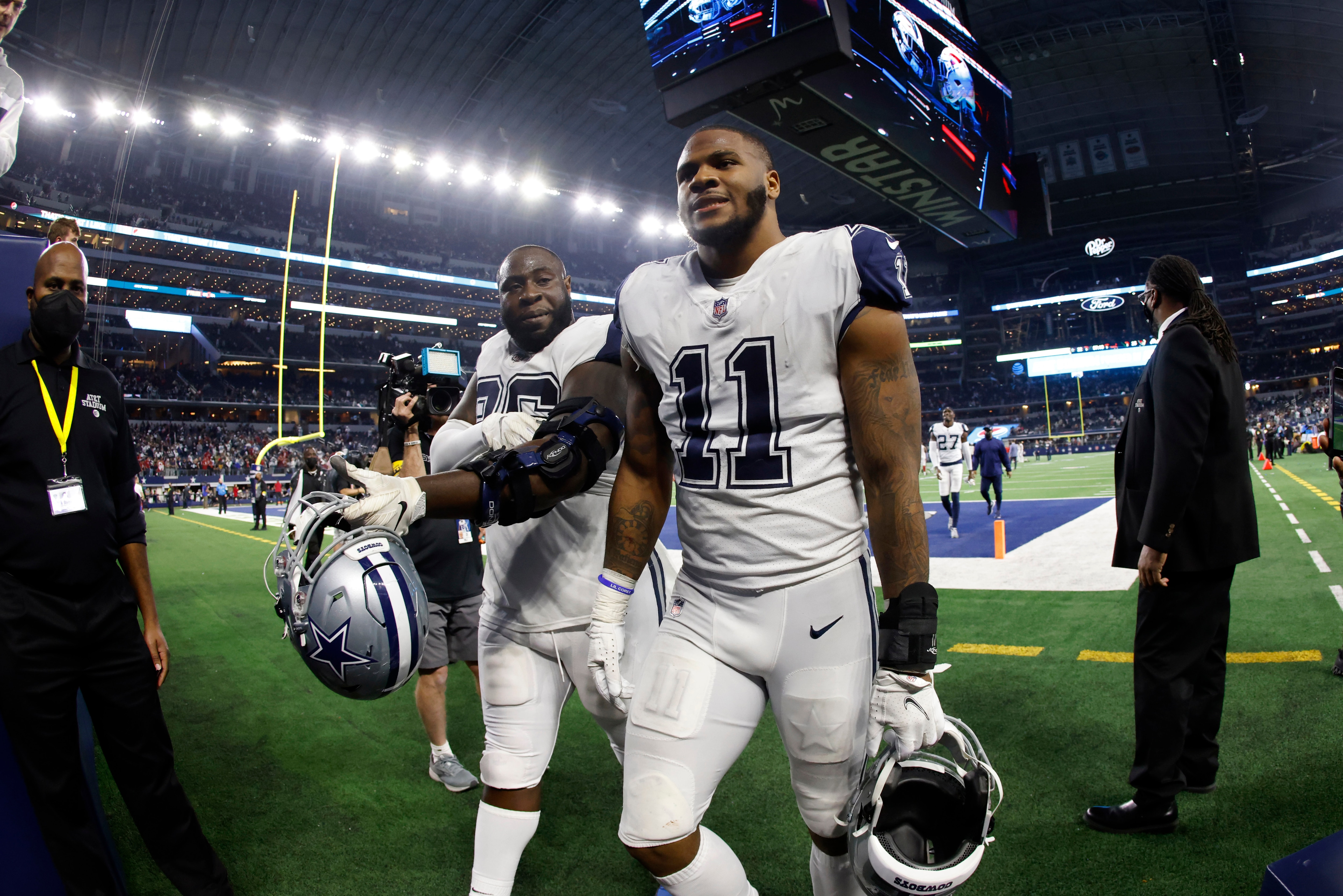 Dallas Cowboys' Micah Parsons (11) and Neville Gallimore leave the field after an NFL football game against the Arizona Cardinals Sunday, Jan. 2, 2022, in Arlington, Texas. The Cardinals won 25-22. (AP Photo/Ron Jenkins)