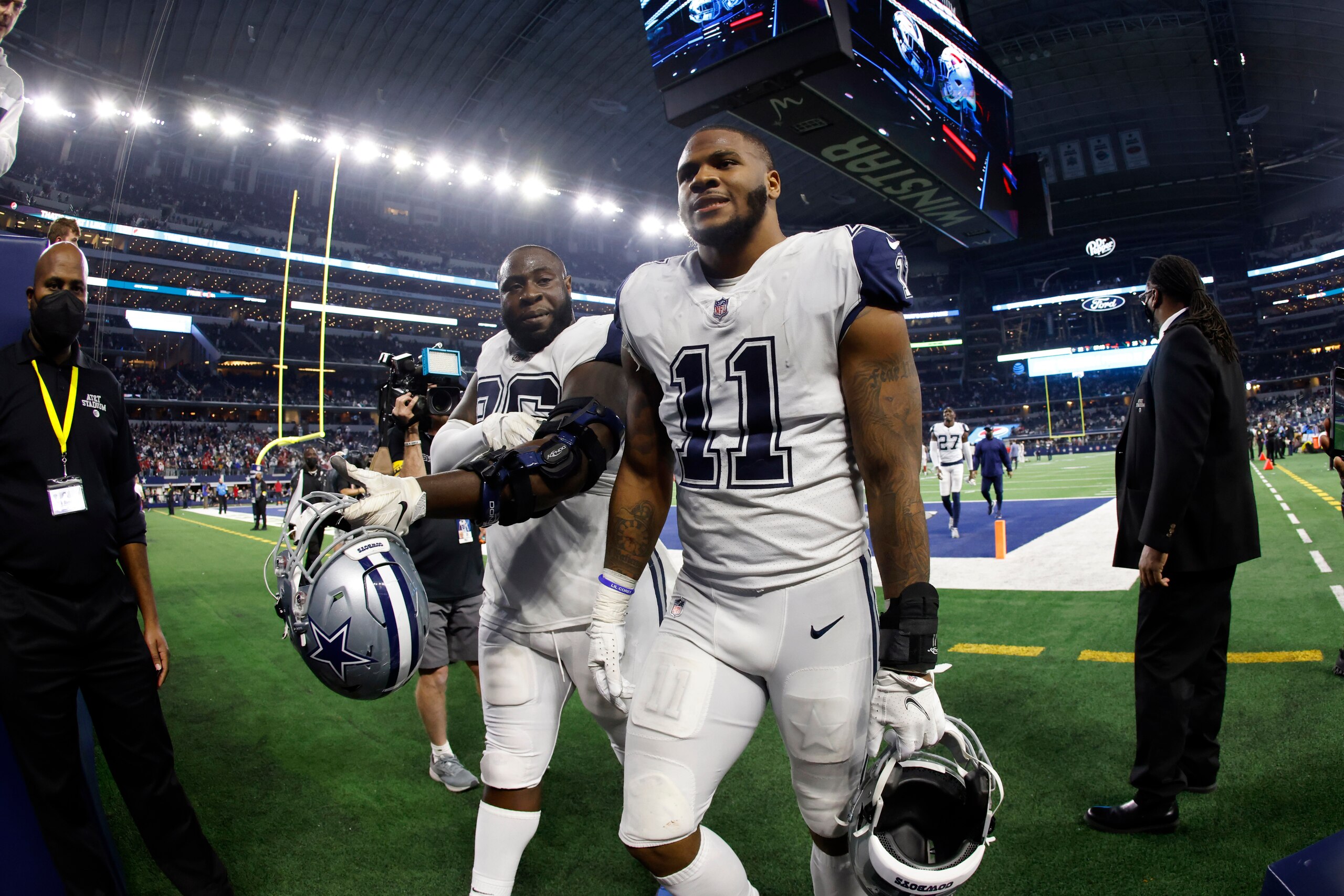 Dallas Cowboys' Micah Parsons (11) and Neville Gallimore leave the field after an NFL football game against the Arizona Cardinals Sunday, Jan. 2, 2022, in Arlington, Texas. The Cardinals won 25-22. (AP Photo/Ron Jenkins)