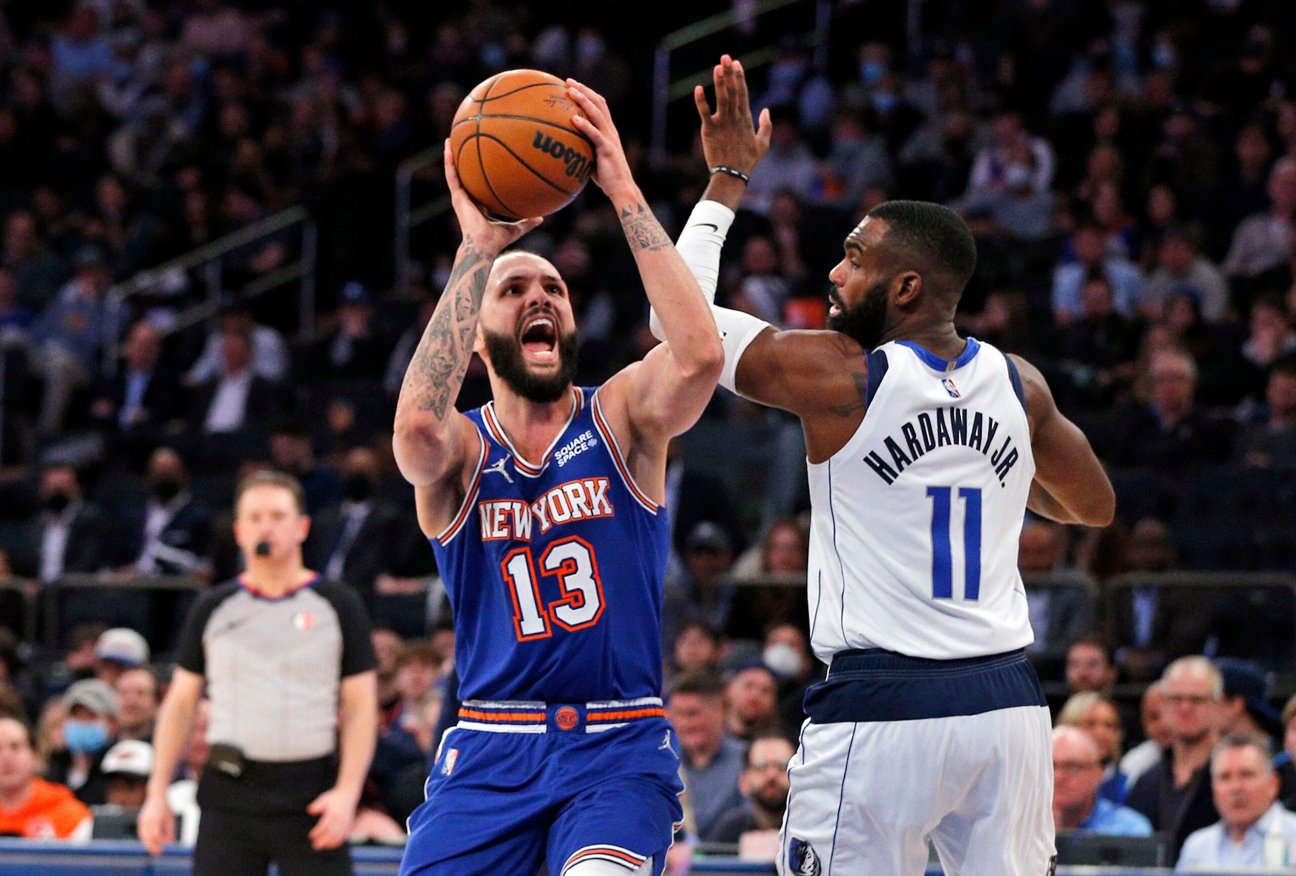 New York Knicks guard Evan Fournier (13) reacts after being fouled by Dallas Mavericks forward Tim Hardaway Jr. (11) during the second half of an NBA basketball game, Wednesday, Jan. 12, 2022, in New York. (AP Photo/Noah K. Murray)