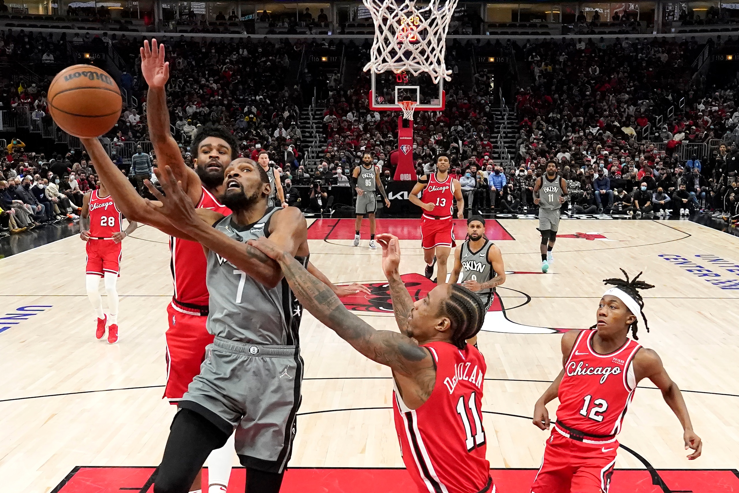 Chicago Bulls' DeMar DeRozan (11) fouls Brooklyn Nets' Kevin Durant (7) as Coby White also defends during the second half of an NBA basketball game Wednesday, Jan. 12, 2022, in Chicago. The Nets won 138-112. (AP Photo/Charles Rex Arbogast) Chicago Bulls' DeMar DeRozan (11) fouls Brooklyn Nets' Kevin Durant (7) as Coby White also defends during the second half of an NBA basketball game Wednesday, Jan. 12, 2022, in Chicago. The Nets won 138-112. (AP Photo/Charles Rex Arbogast)