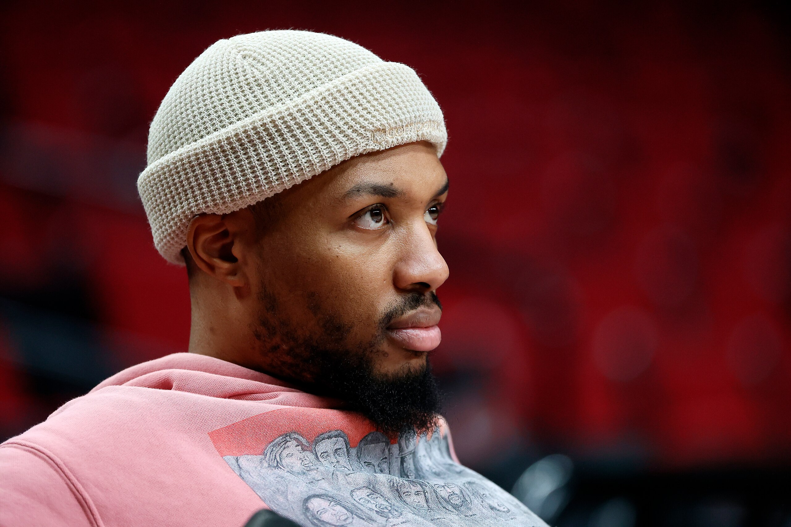 PORTLAND, OREGON - JANUARY 05: Damian Lillard # 0 of the Portland Trail Blazers looks on from the bench prior to the game against the Miami Heat at Moda Center on January 05, 2022 in Portland, Oregon. NOTE TO USER: User expressly acknowledges and agrees that, by downloading and or using this photograph, User is consenting to the terms and conditions of the Getty Images License Agreement. (Photo by Soobum Im/Getty Images)