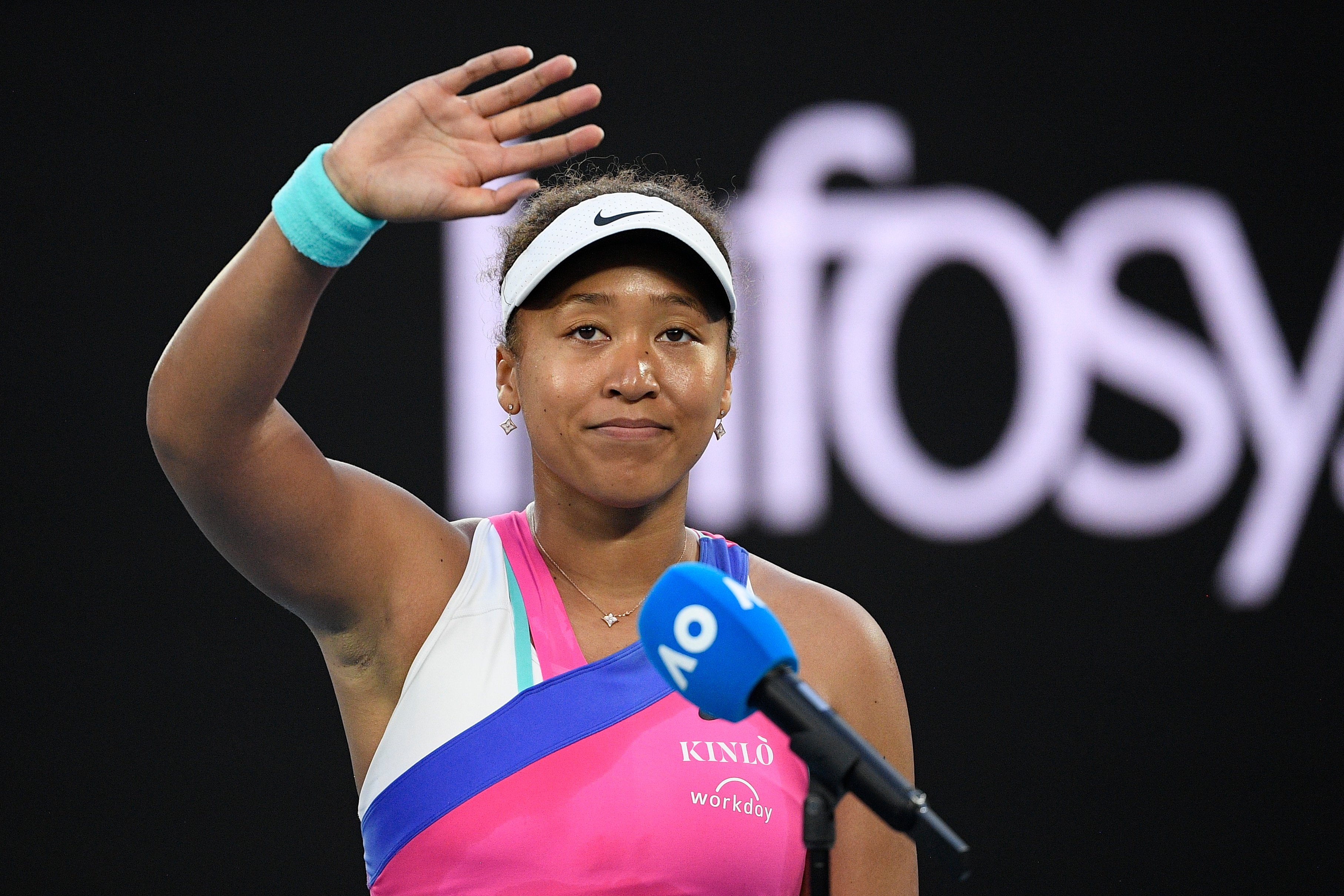 Naomi Osaka of Japan waves following her interview after defeating Madison Brengle of the U.S. in their second round match at the Australian Open tennis championships in Melbourne, Australia, Wednesday, Jan. 19, 2022. (AP Photo/Andy Brownbill)