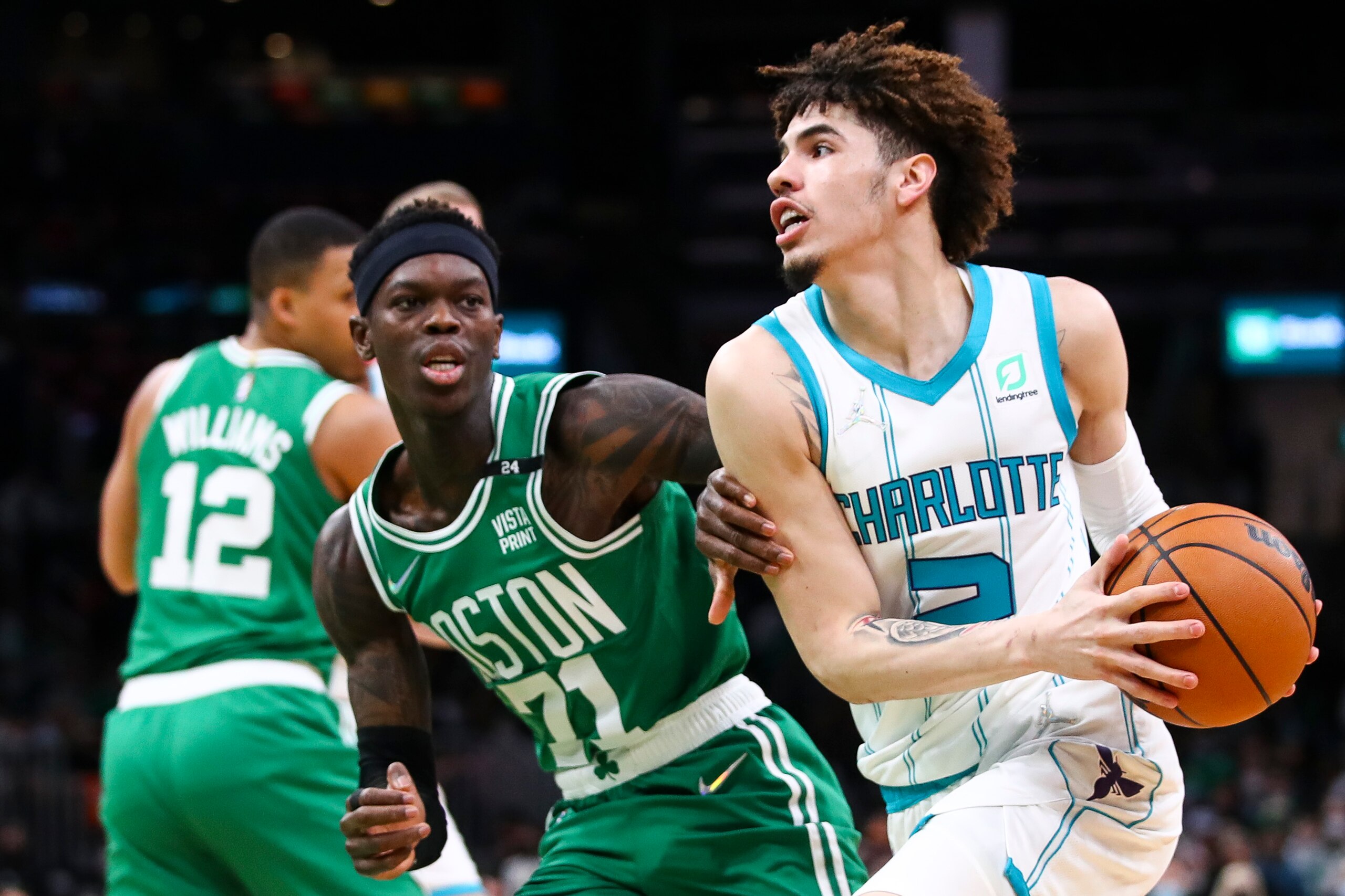 BOSTON, MA - JANUARY 19:  LaMelo Ball #2 of the Charlotte Hornets drives to the basket past Dennis Schroder #71 of the Boston Celtics during a game at TD Garden on January 19, 2022 in Boston, Massachusetts. NOTE TO USER: User expressly acknowledges and agrees that, by downloading and or using this photograph, User is consenting to the terms and conditions of the Getty Images License Agreement. (Photo by Adam Glanzman/Getty Images)