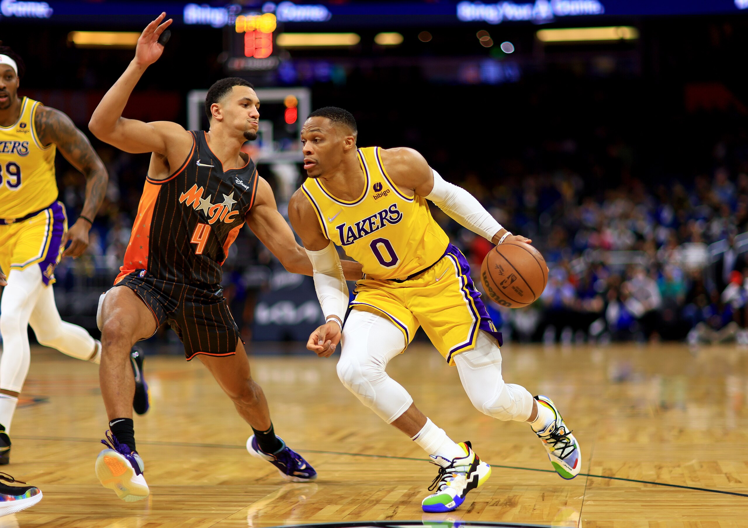 ORLANDO, FLORIDA - JANUARY 21: Russell Westbrook #0 of the Los Angeles Lakers drives on Cole Anthony #50 of the Orlando Magic during a game  at Amway Center on January 21, 2022 in Orlando, Florida. NOTE TO USER: User expressly acknowledges and agrees that, by downloading and or using this photograph, User is consenting to the terms and conditions of the Getty Images License Agreement. (Photo by Mike Ehrmann/Getty Images)