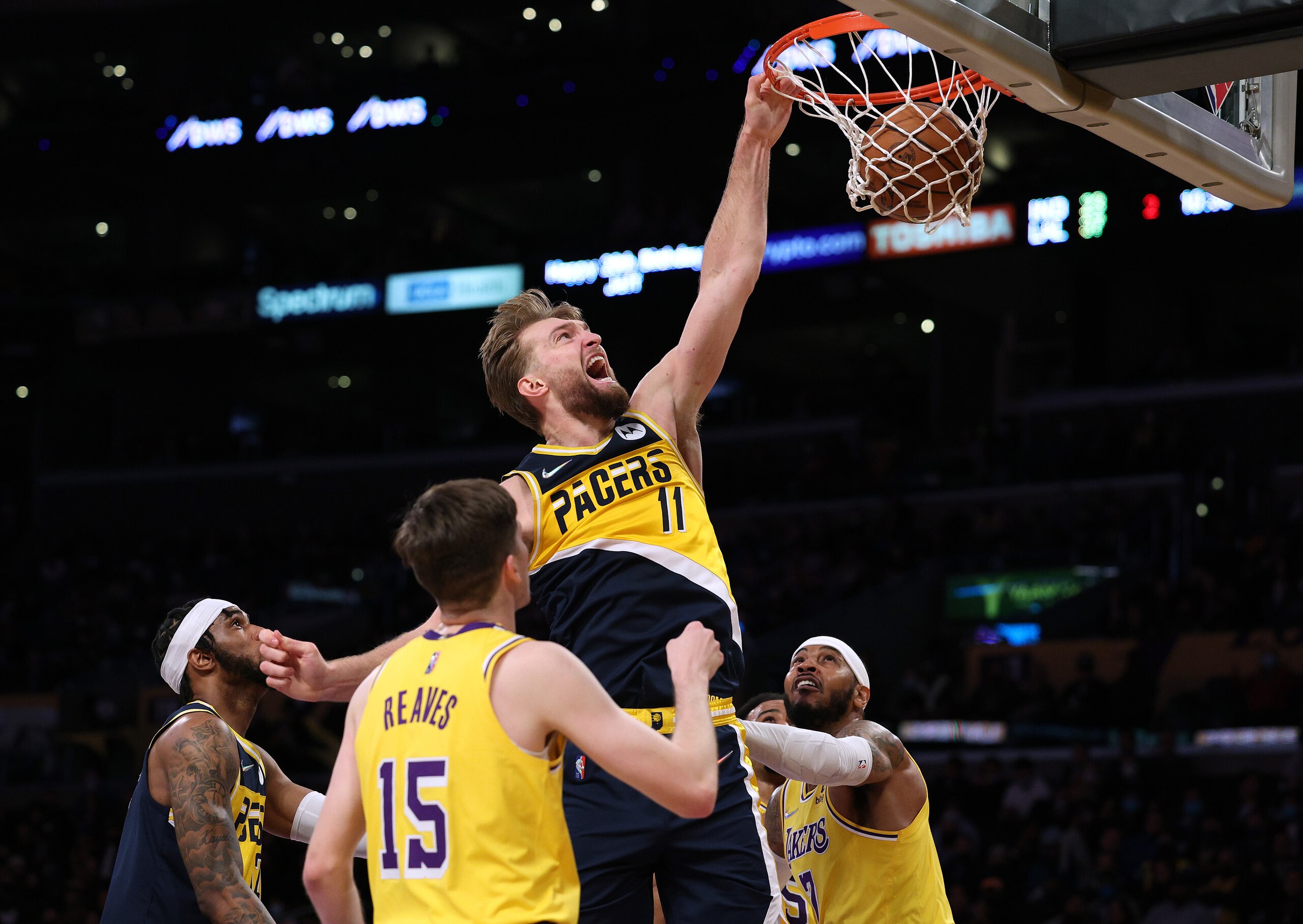 LOS ANGELES, CALIFORNIA - JANUARY 19: Domantas Sabonis #11 of the Indiana Pacers reacts as he dunks between Carmelo Anthony #7 and Austin Reaves #15 of the Los Angeles Lakers during the first half at Crypto.com Arena on January 19, 2022 in Los Angeles, California. NOTE TO USER: User expressly acknowledges and agrees that, by downloading and/or using this Photograph, user is consenting to the terms and conditions of the Getty Images License Agreement. Mandatory Copyright Notice: Copyright 2022 NBAE (Photo by Harry How/Getty Images) LOS ANGELES, CALIFORNIA - JANUARY 19: Domantas Sabonis #11 of the Indiana Pacers reacts as he dunks between Carmelo Anthony #7 and Austin Reaves #15 of the Los Angeles Lakers during the first half at Crypto.com Arena on January 19, 2022 in Los Angeles, California. NOTE TO USER: User expressly acknowledges and agrees that, by downloading and/or using this Photograph, user is consenting to the terms and conditions of the Getty Images License Agreement. Mandatory Copyright Notice: Copyright 2022 NBAE (Photo by Harry How/Getty Images)