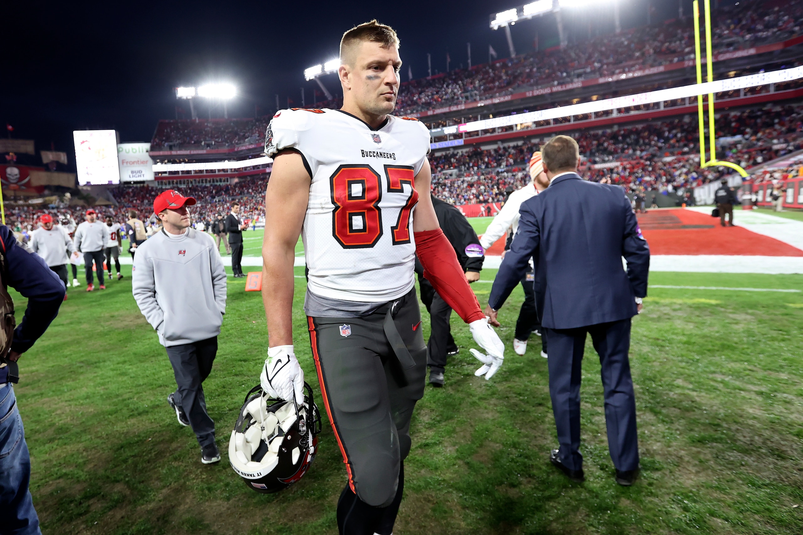 Tampa Bay Buccaneers tight end Rob Gronkowski (87) leaves the field after the team lost to the Los Angeles Rams during an NFL divisional round playoff football game Sunday, Jan. 23, 2022, in Tampa, Fla. (AP Photo/Mark LoMoglio) Tampa Bay Buccaneers tight end Rob Gronkowski (87) leaves the field after the team lost to the Los Angeles Rams during an NFL divisional round playoff football game Sunday, Jan. 23, 2022, in Tampa, Fla. (AP Photo/Mark LoMoglio)