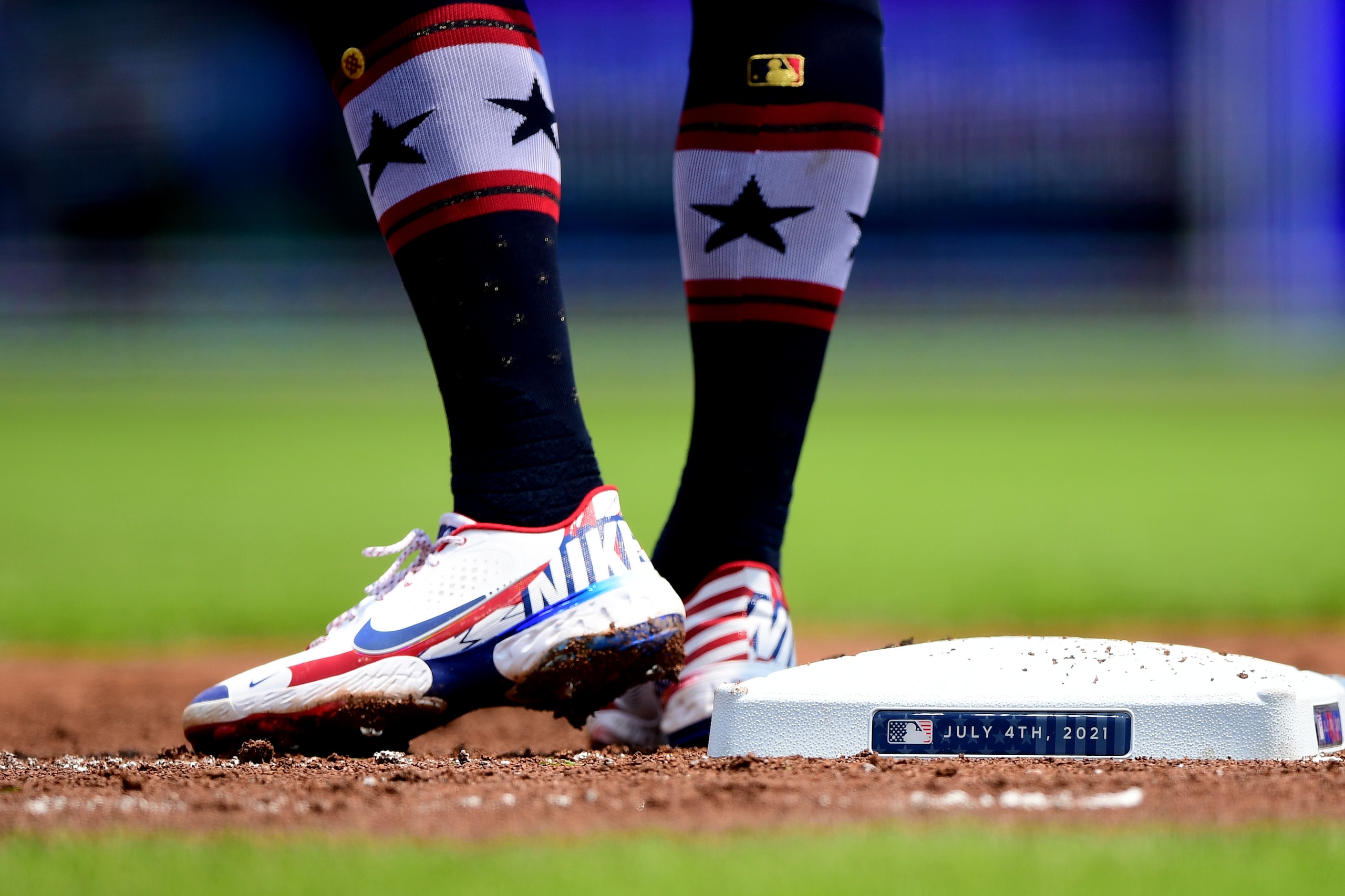 CINCINNATI, OHIO - JULY 04: A detailed view of the cleats of Joey Votto #19 of the Cincinnati Reds and the first base Independence Day logo in the first inning during their game against the Chicago Cubs at Great American Ball Park on July 04, 2021 in Cincinnati, Ohio. (Photo by Emilee Chinn/Getty Images)