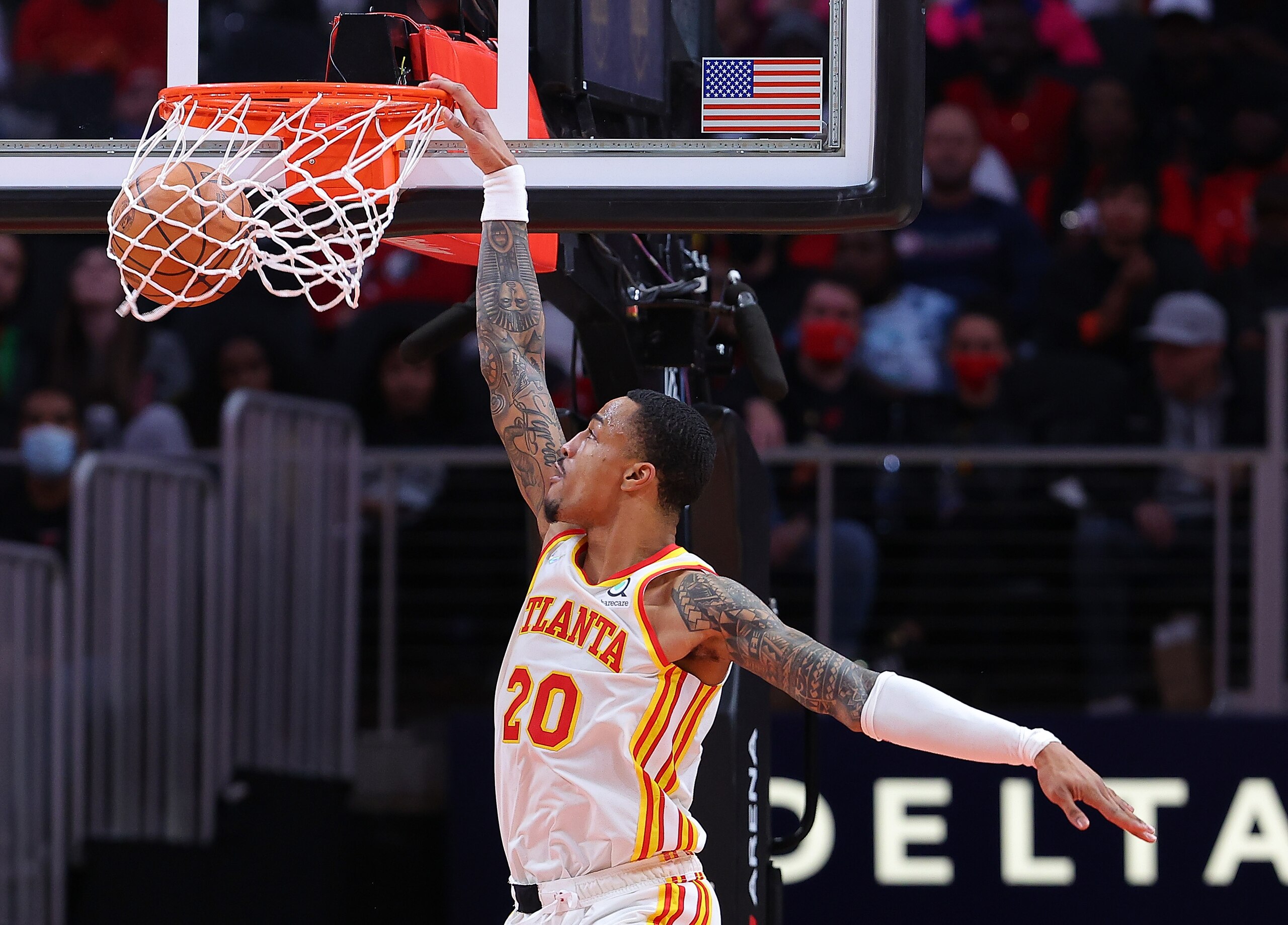 ATLANTA, GEORGIA - JANUARY 19:  John Collins #20 of the Atlanta Hawks dunks against the Minnesota Timberwolves during the first half at State Farm Arena on January 19, 2022 in Atlanta, Georgia.  NOTE TO USER: User expressly acknowledges and agrees that, by downloading and or using this photograph, User is consenting to the terms and conditions of the Getty Images License Agreement. (Photo by Kevin C. Cox/Getty Images)