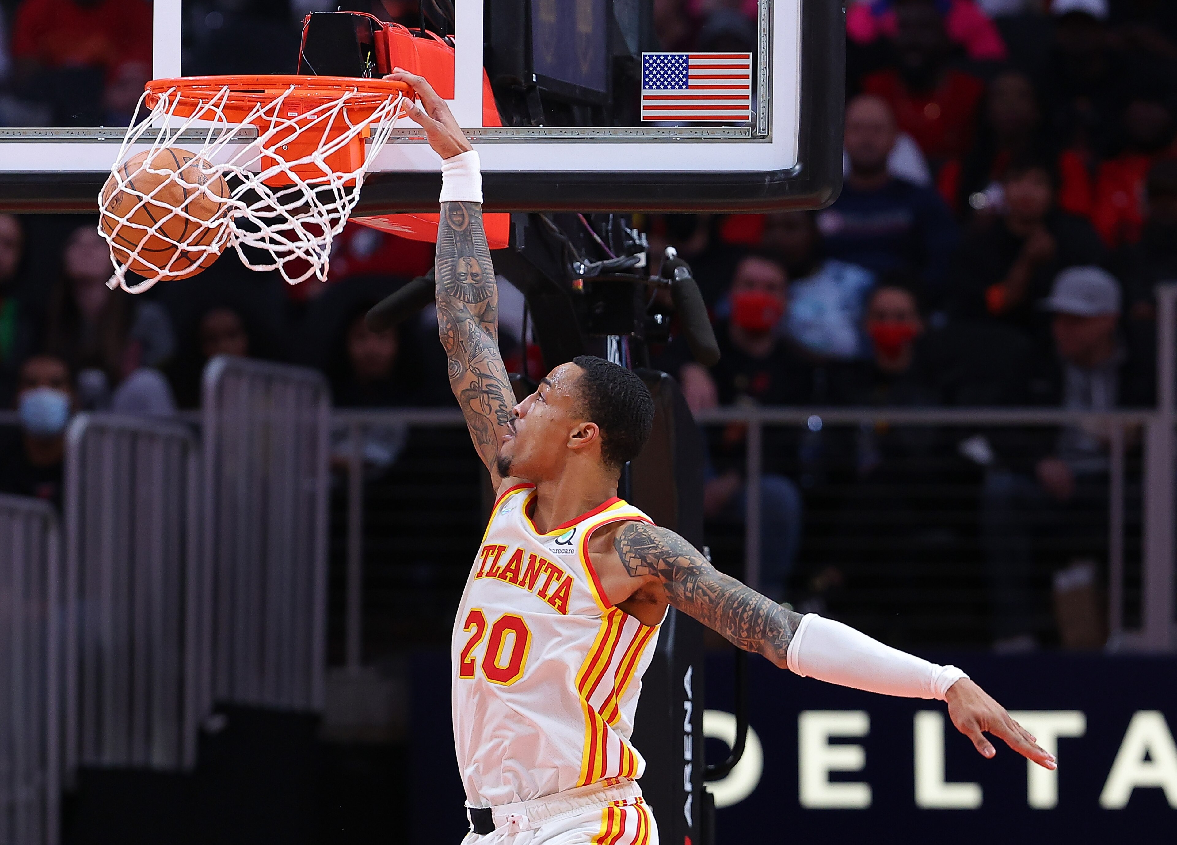 ATLANTA, GEORGIA - JANUARY 19:  John Collins #20 of the Atlanta Hawks dunks against the Minnesota Timberwolves during the first half at State Farm Arena on January 19, 2022 in Atlanta, Georgia.  NOTE TO USER: User expressly acknowledges and agrees that, by downloading and or using this photograph, User is consenting to the terms and conditions of the Getty Images License Agreement. (Photo by Kevin C. Cox/Getty Images)