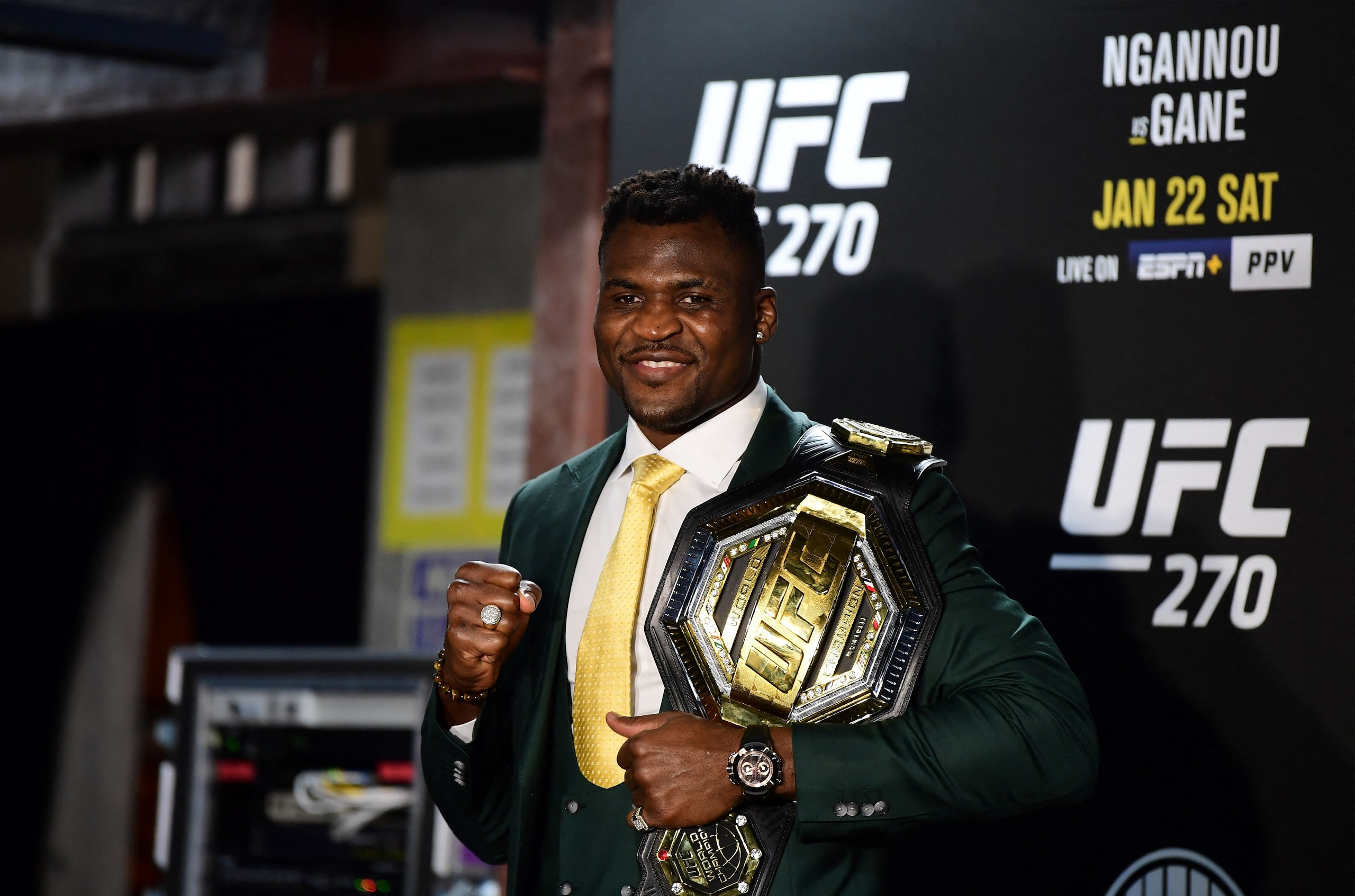 Champion Cameroon's Francis Ngannou holds the championship belt in the press room after defeating French Cyril Gane in their UFC 270 championship fight in Anaheim on January 22, 2022. (Photo by Frederic J. BROWN / AFP) (Photo by FREDERIC J. BROWN/AFP via Getty Images)