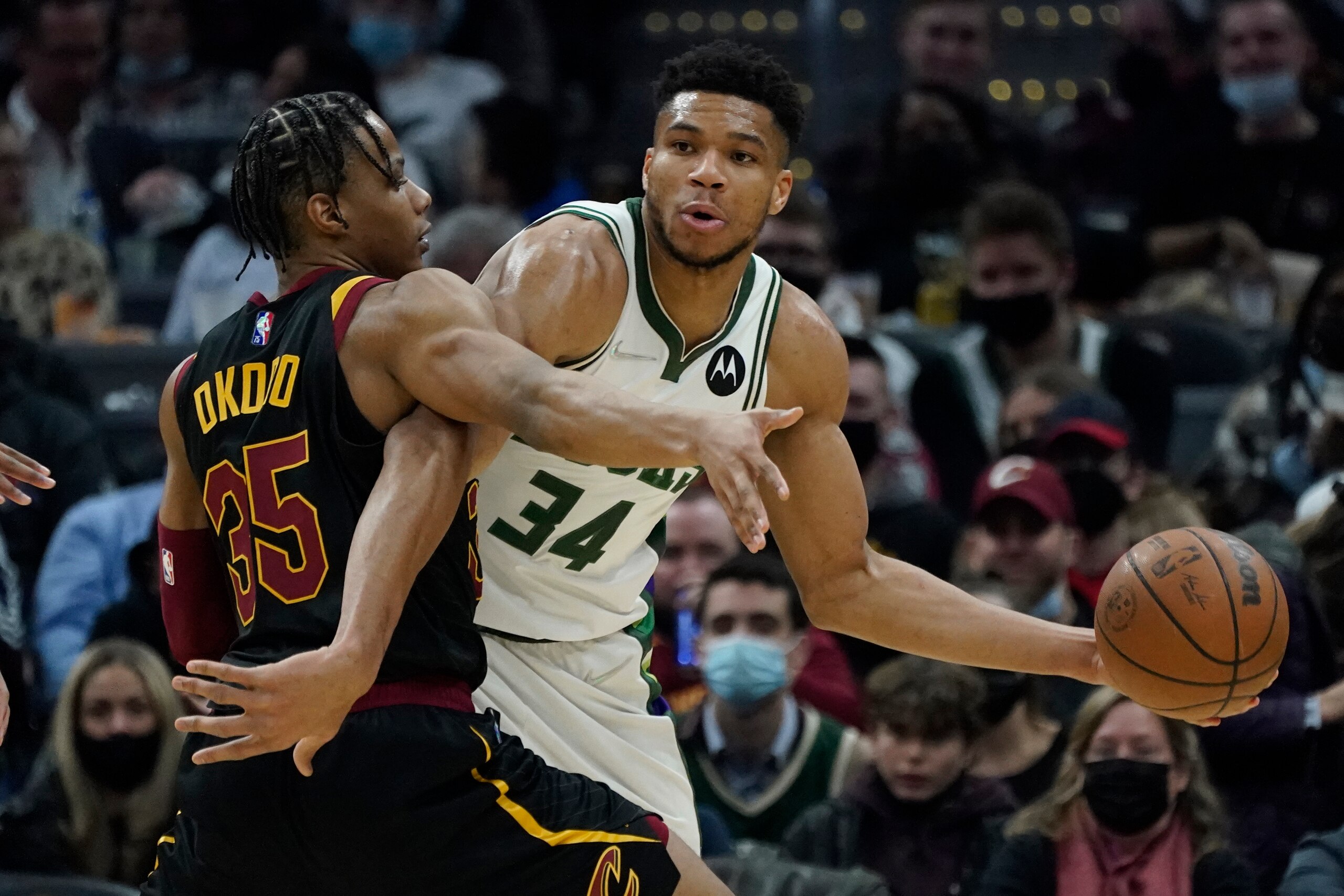 Milwaukee Bucks' Giannis Antetokounmpo (34) drives against Cleveland Cavaliers' Isaac Okoro (35) in the second half of an NBA basketball game, Wednesday, Jan. 26, 2022, in Cleveland. (AP Photo/Tony Dejak)