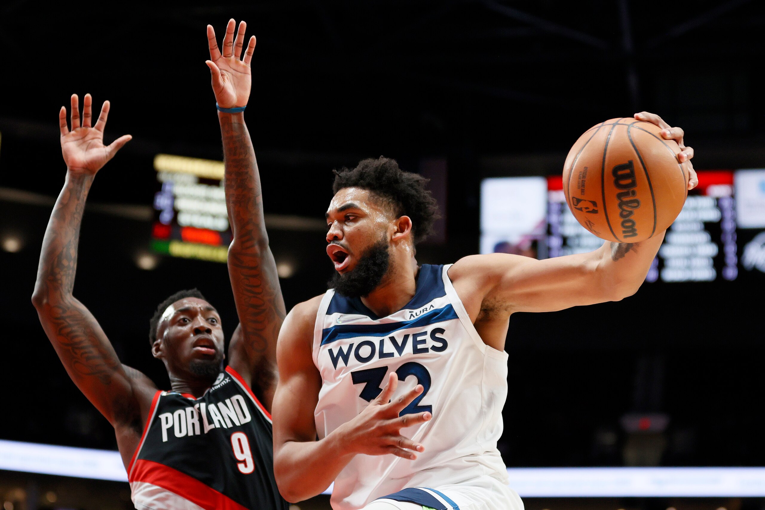 PORTLAND, OREGON - JANUARY 25: Nassir Little #9 of the Portland Trail Blazers defends as Karl-Anthony Towns #32 of the Minnesota Timberwolves looks to pass during the second halfat Moda Center on January 25, 2022 in Portland, Oregon. NOTE TO USER: User expressly acknowledges and agrees that, by downloading and/or using this photograph, User is consenting to the terms and conditions of the Getty Images License Agreement. (Photo by Steph Chambers/Getty Images)