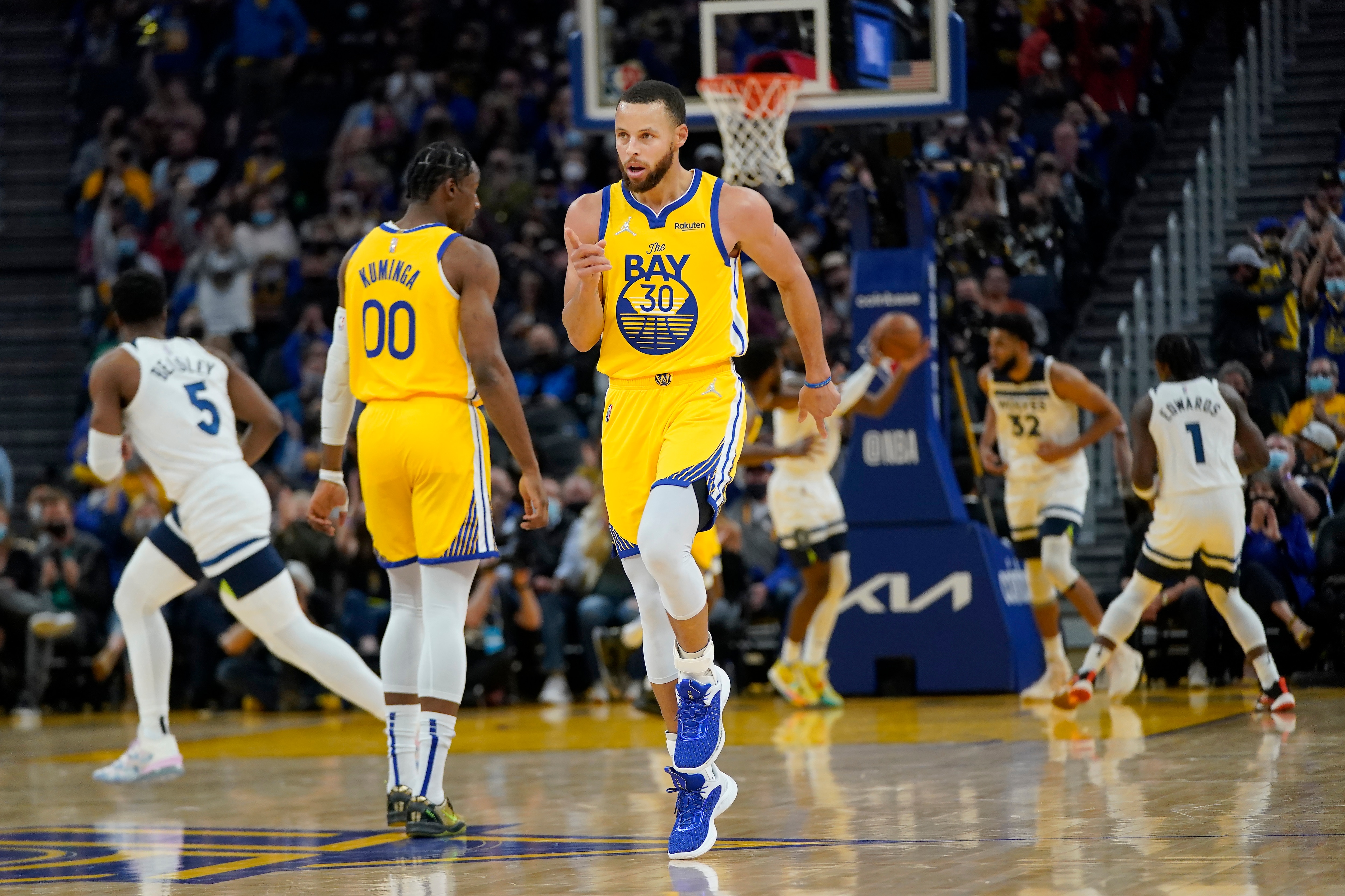 Golden State Warriors guard Stephen Curry (30) reacts after shooting a 3-point basket against the Minnesota Timberwolves during the first half of an NBA basketball game in San Francisco, Thursday, Jan. 27, 2022. (AP Photo/Jeff Chiu)