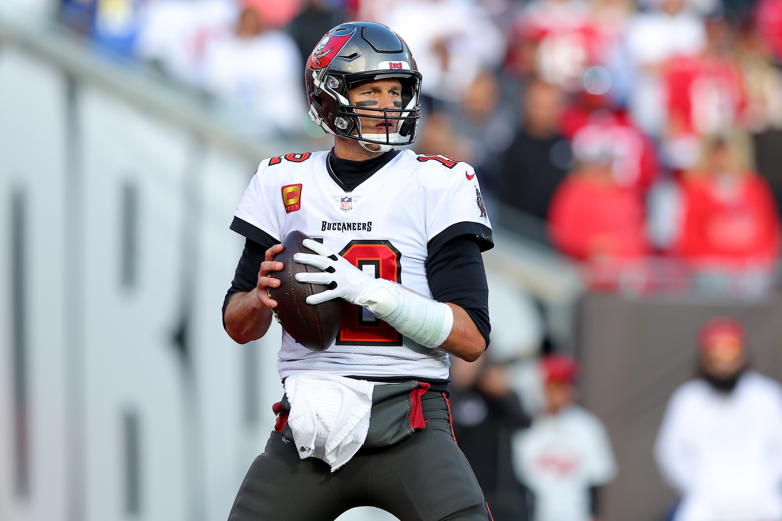 TAMPA, FLORIDA - JANUARY 23: Tom Brady #12 of the Tampa Bay Buccaneers looks to pass against the Los Angeles Rams during the first half in the NFC Divisional Playoff game at Raymond James Stadium on January 23, 2022 in Tampa, Florida. (Photo by Kevin C. Cox/Getty Images)
