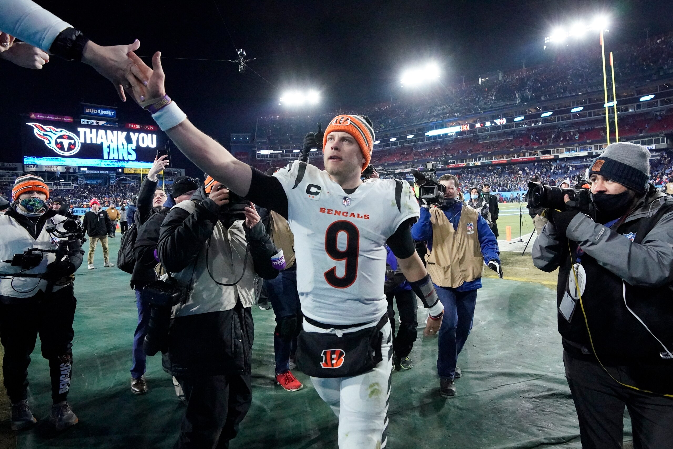 Cincinnati Bengals quarterback Joe Burrow slaps hands with a fan as he leaves the field after the Bengals beat the Tennessee Titans in an NFL divisional round playoff football game Monday, Jan. 24, 2022, in Nashville, Tenn. (AP Photo/Mark Humphrey)